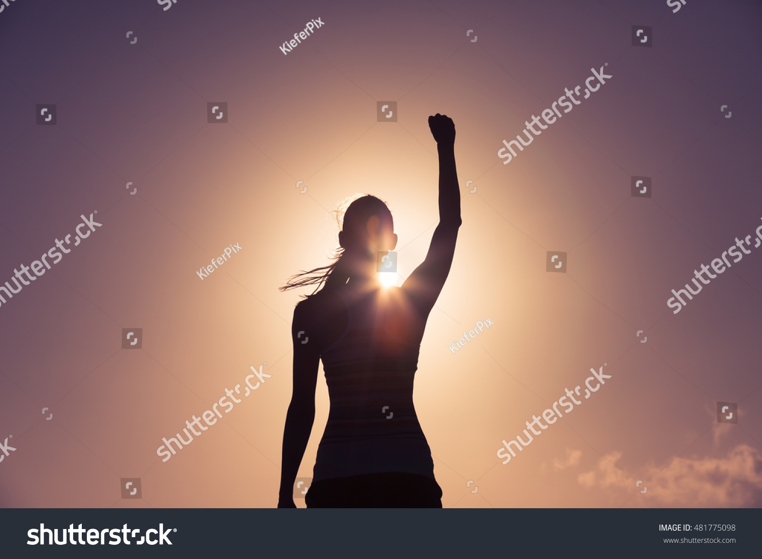 Strong confident woman with her fist up in the air.  #481775098