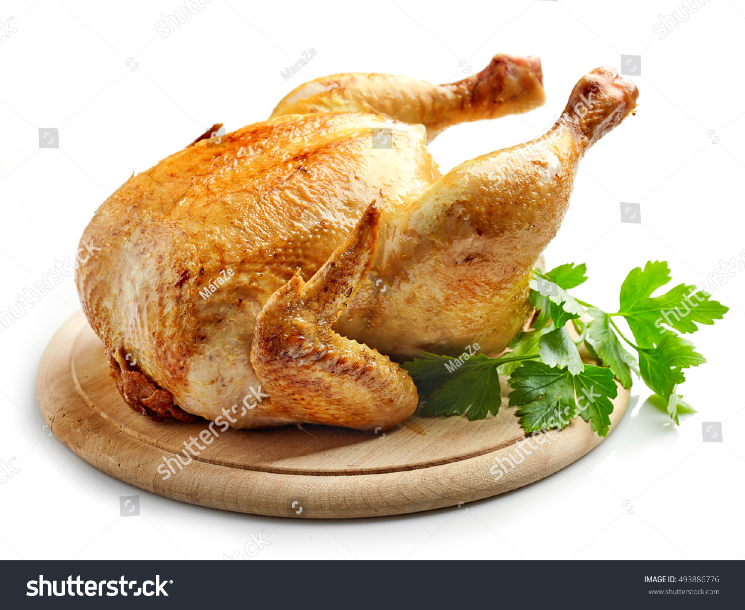 whole roasted chicken on wooden cutting board #493886776