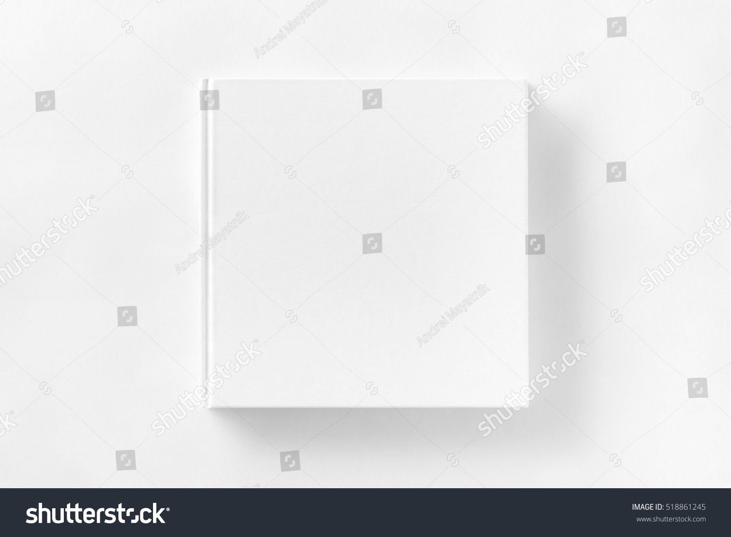 Mockup of closed blank square book at white textured paper background. #518861245