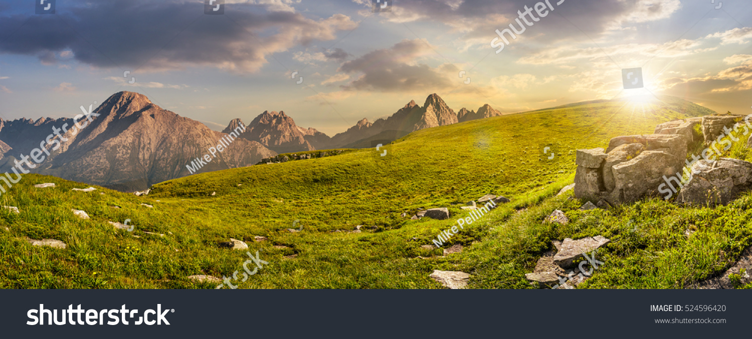 High Tatra mountain summer landscape. meadow with huge stones among the grass on top of the hillside near the peak of mountain range at sunset #524596420
