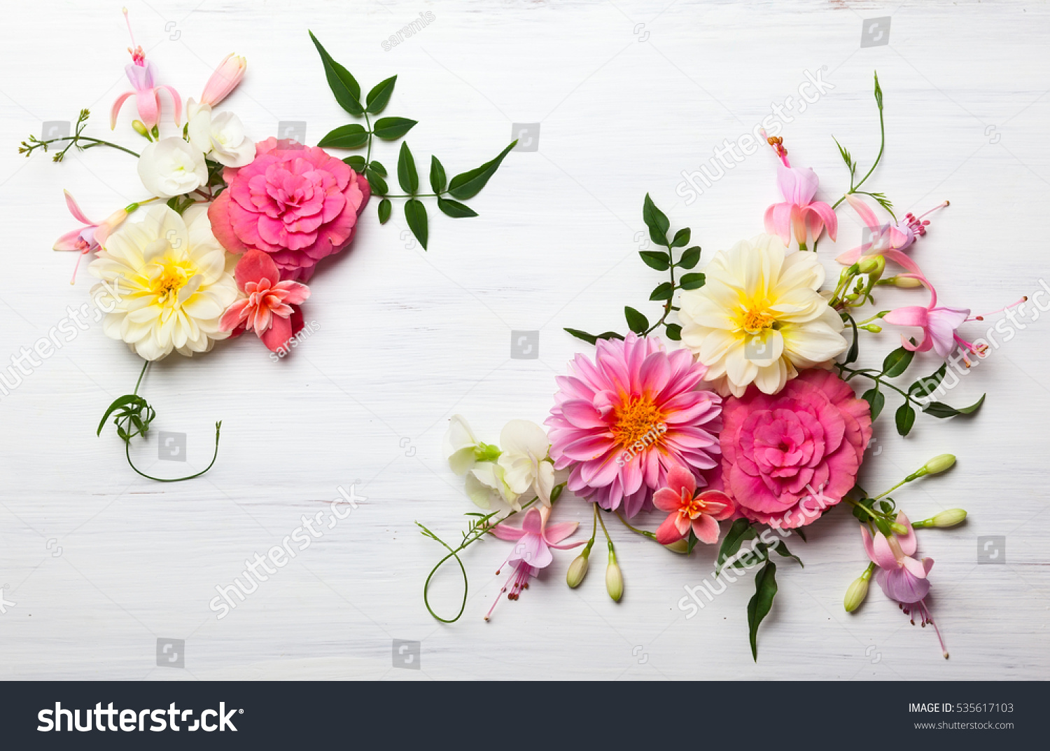 Festive flower composition on the white wooden background. Overhead view. #535617103
