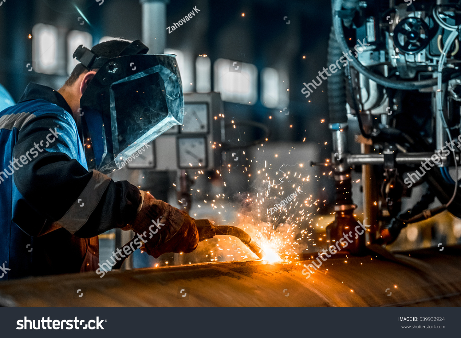 man welds at the factory #539932924