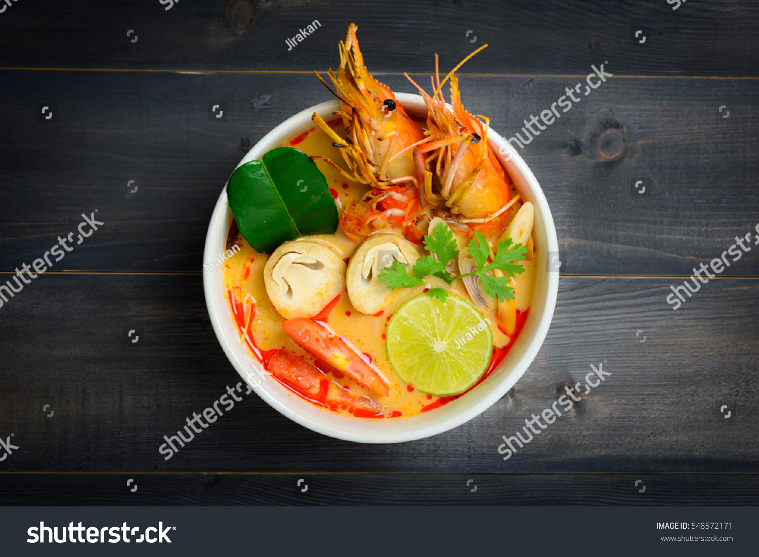 Tom Yum Goong Spicy Sour Soup on wooden table top view, Thai local food #548572171