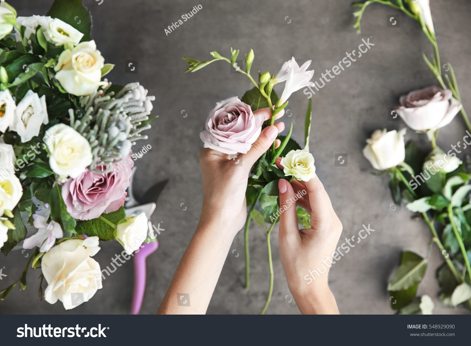 Female florist making beautiful bouquet at flower shop #548929090