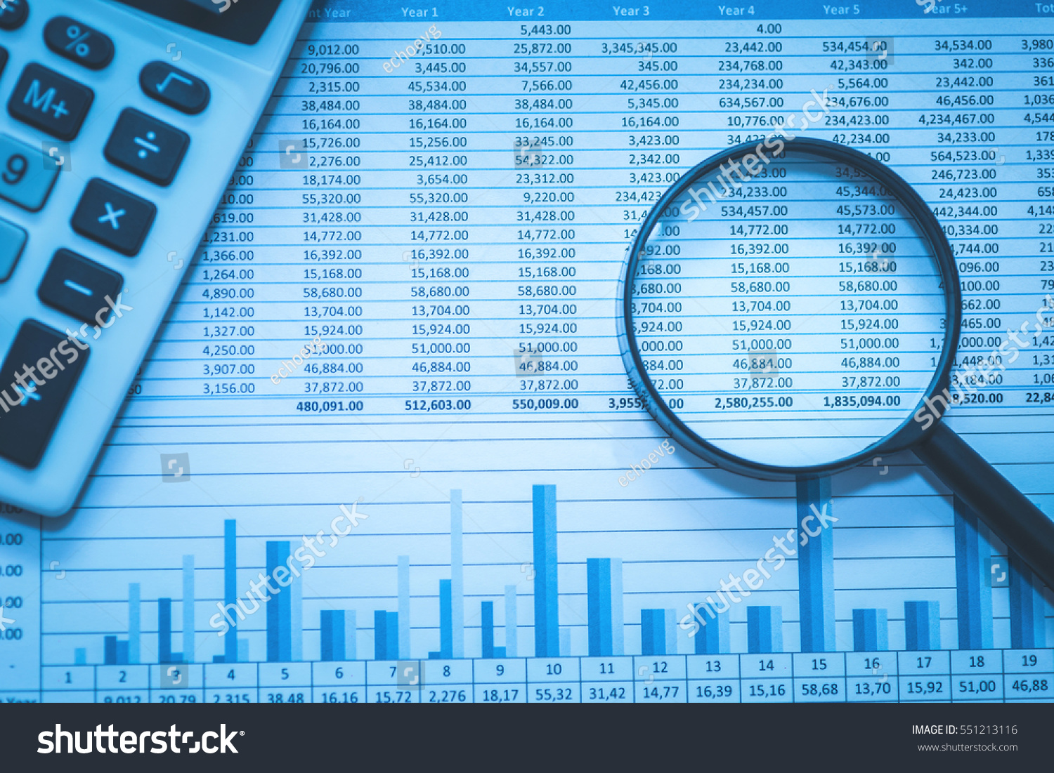 Spreadsheet bank accounts accounting with calculator and magnifying glass. Concept for financial fraud investigation, audit and analysis. #551213116