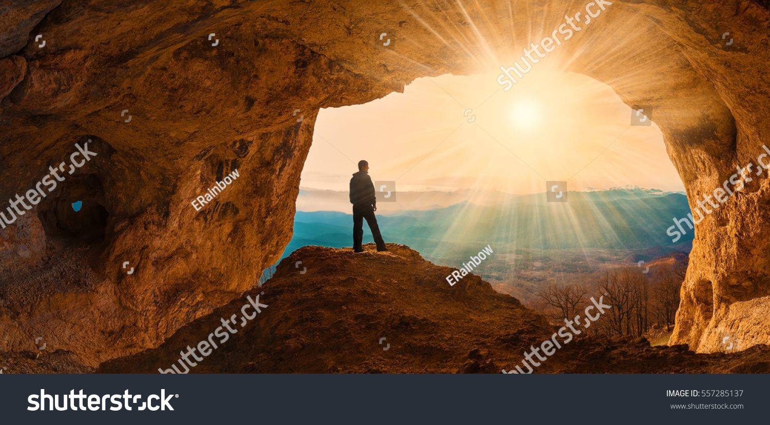 Beautiful amazing sunset. Mountains in north country Russia Caucasus. Unique landscape mainsail. Silhouette of a man. Old cave. Active sport and hobby. Spelunking background. Quest #557285137