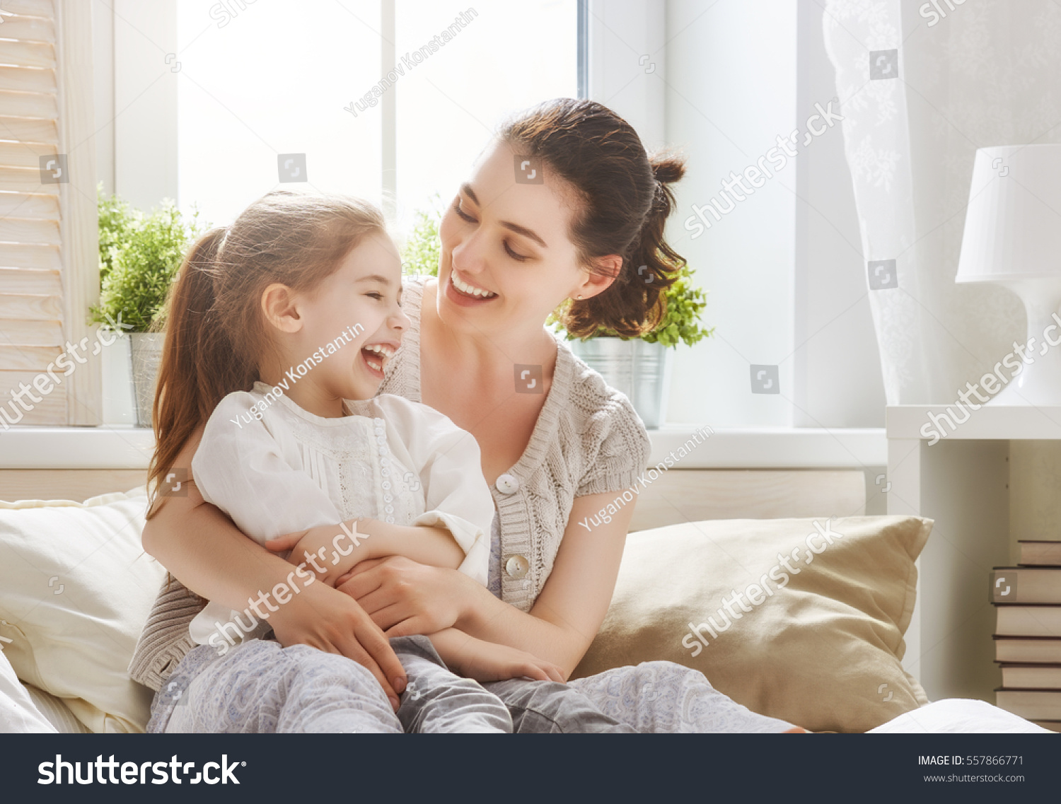Happy loving family. Mother and her daughter child girl playing and hugging. #557866771