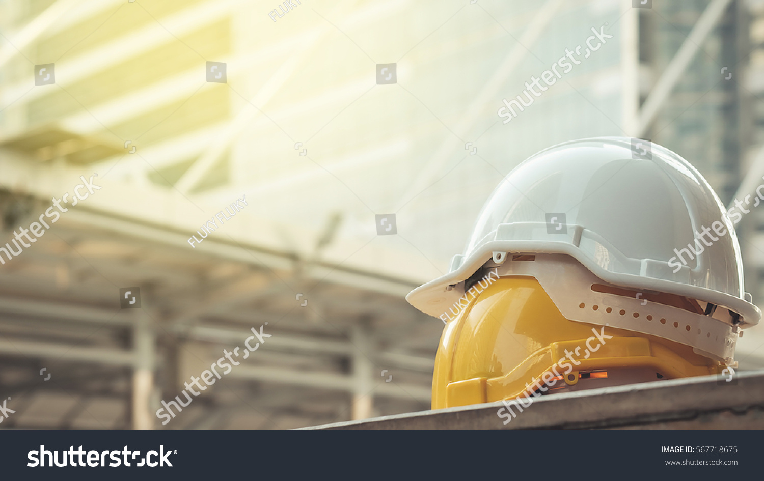 white, yellow hard safety helmet hat for safety project of workman as engineer or worker, on concrete floor on city #567718675