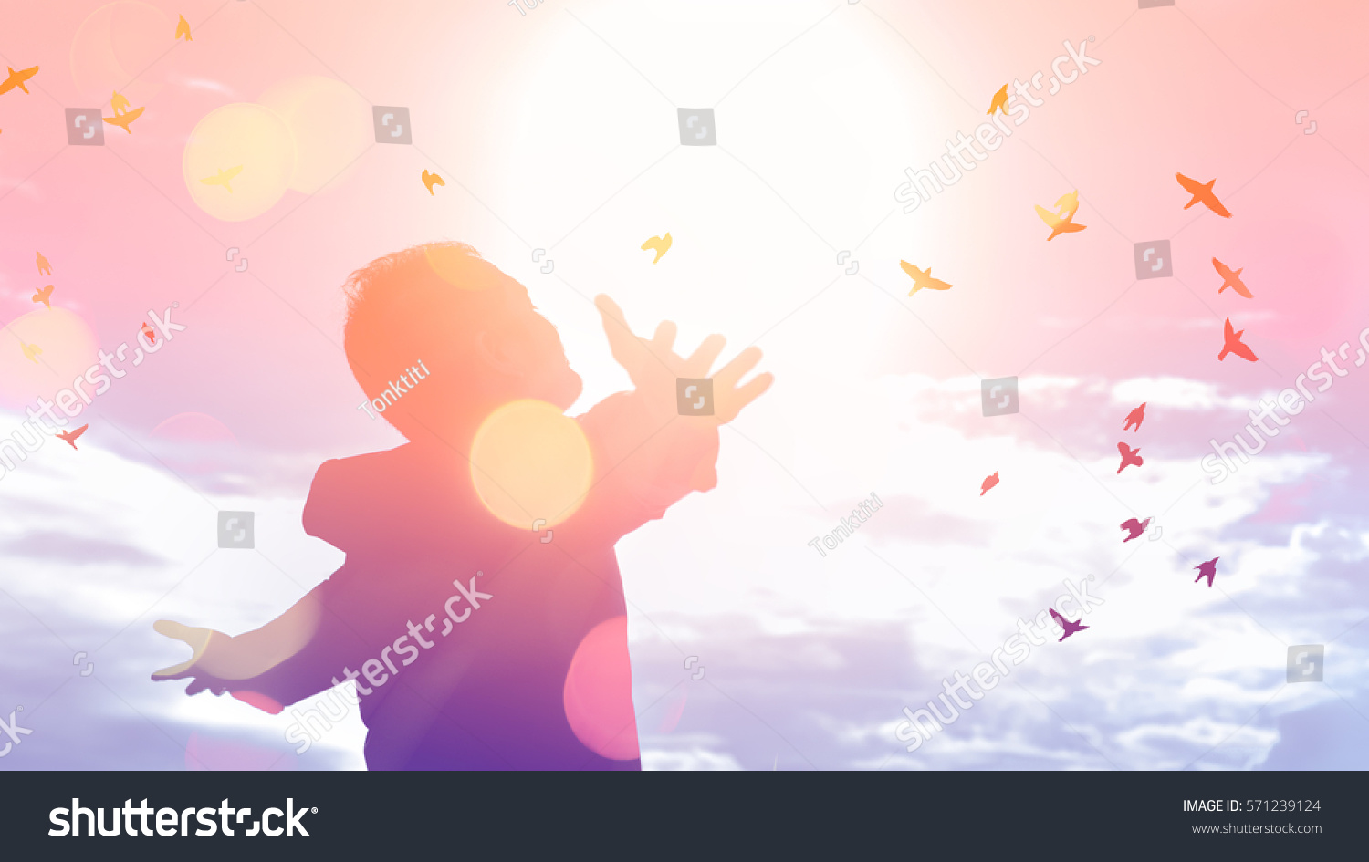 Freedom feel good and travel adventure concept. Copy space of silhouette man rising hands on sunset sky double exposure colorful bokeh and bird fly background. Vintage tone filter effect color style.  #571239124