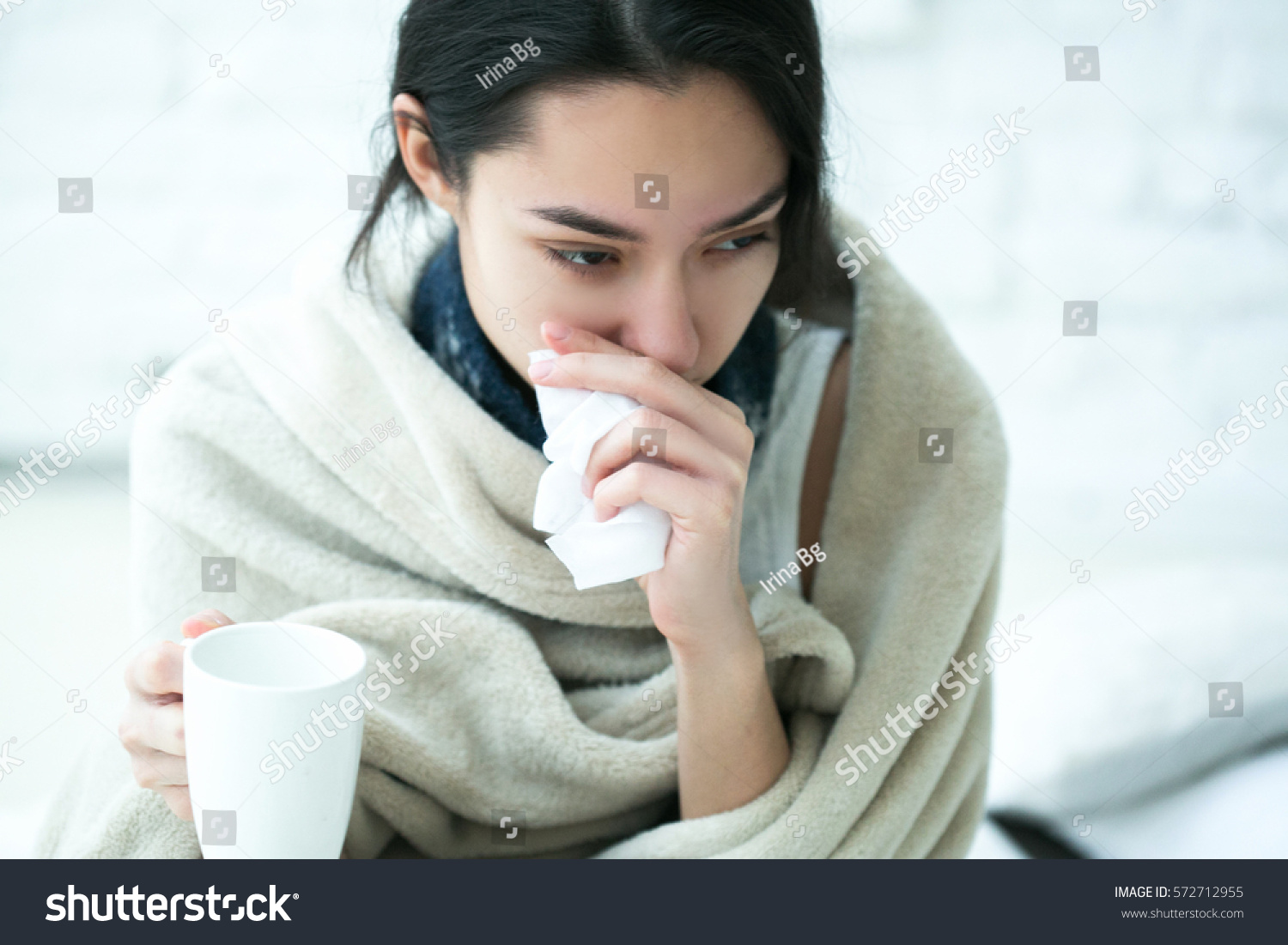 Young girl sick in bed with temperature drinks hot  #572712955