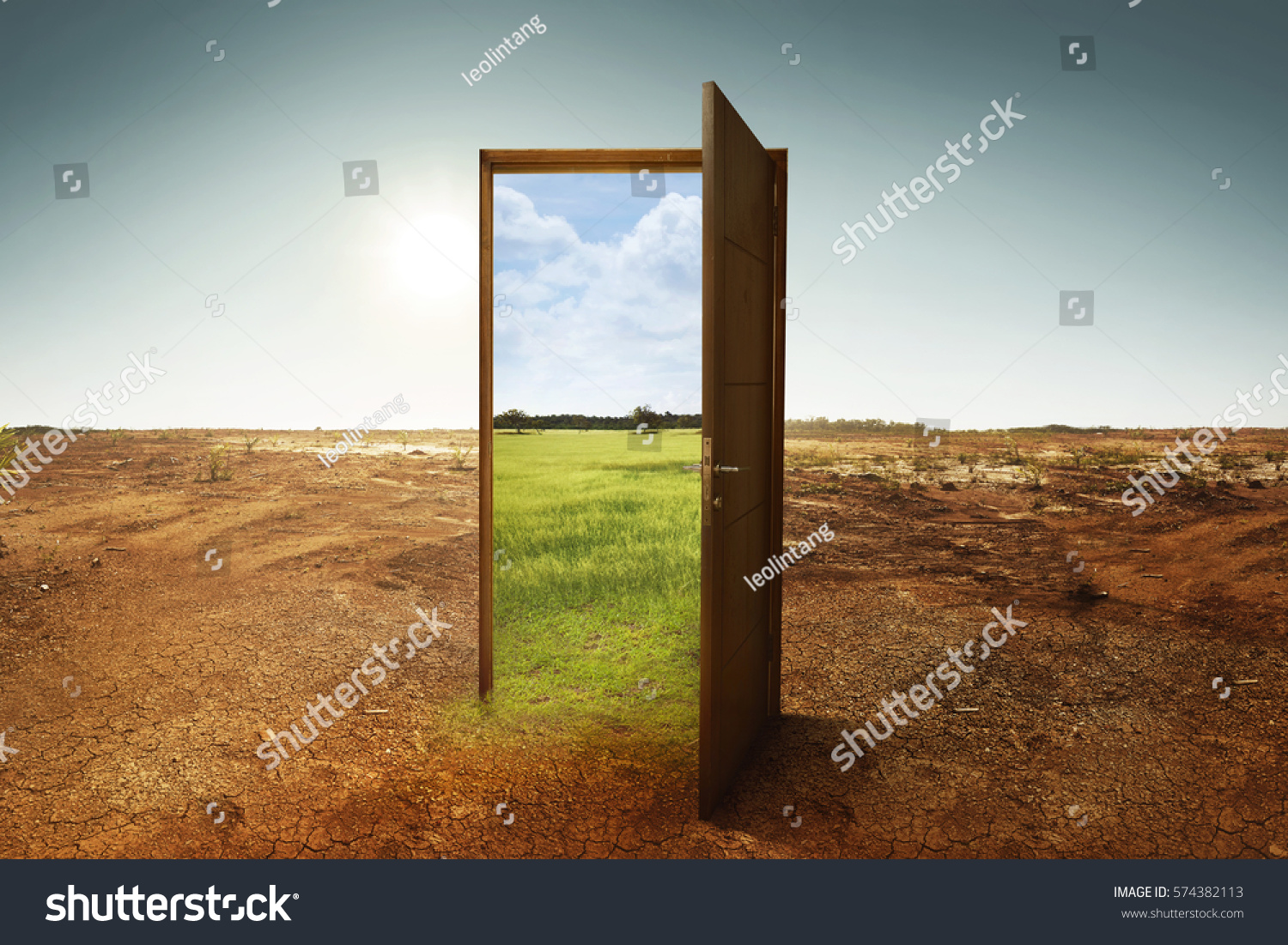 Open wooden door to the new world with green environment. Climate change concept. #574382113