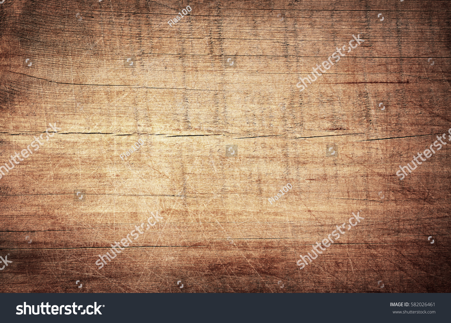 Brown scratched wooden cutting board. Wood texture #582026461