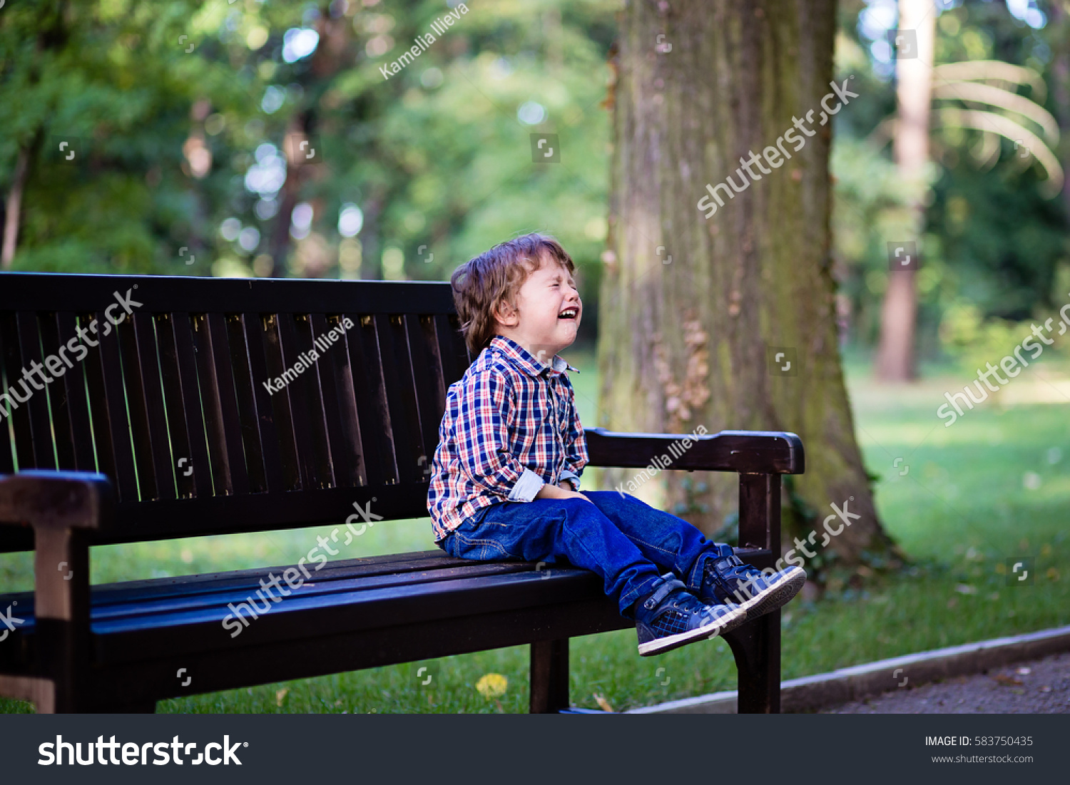 Upset little baby boy crying outdoors. Toddler having tantrum in the park #583750435