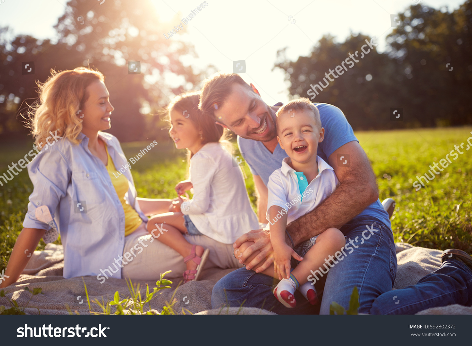 Young family with children having fun in nature  #592802372