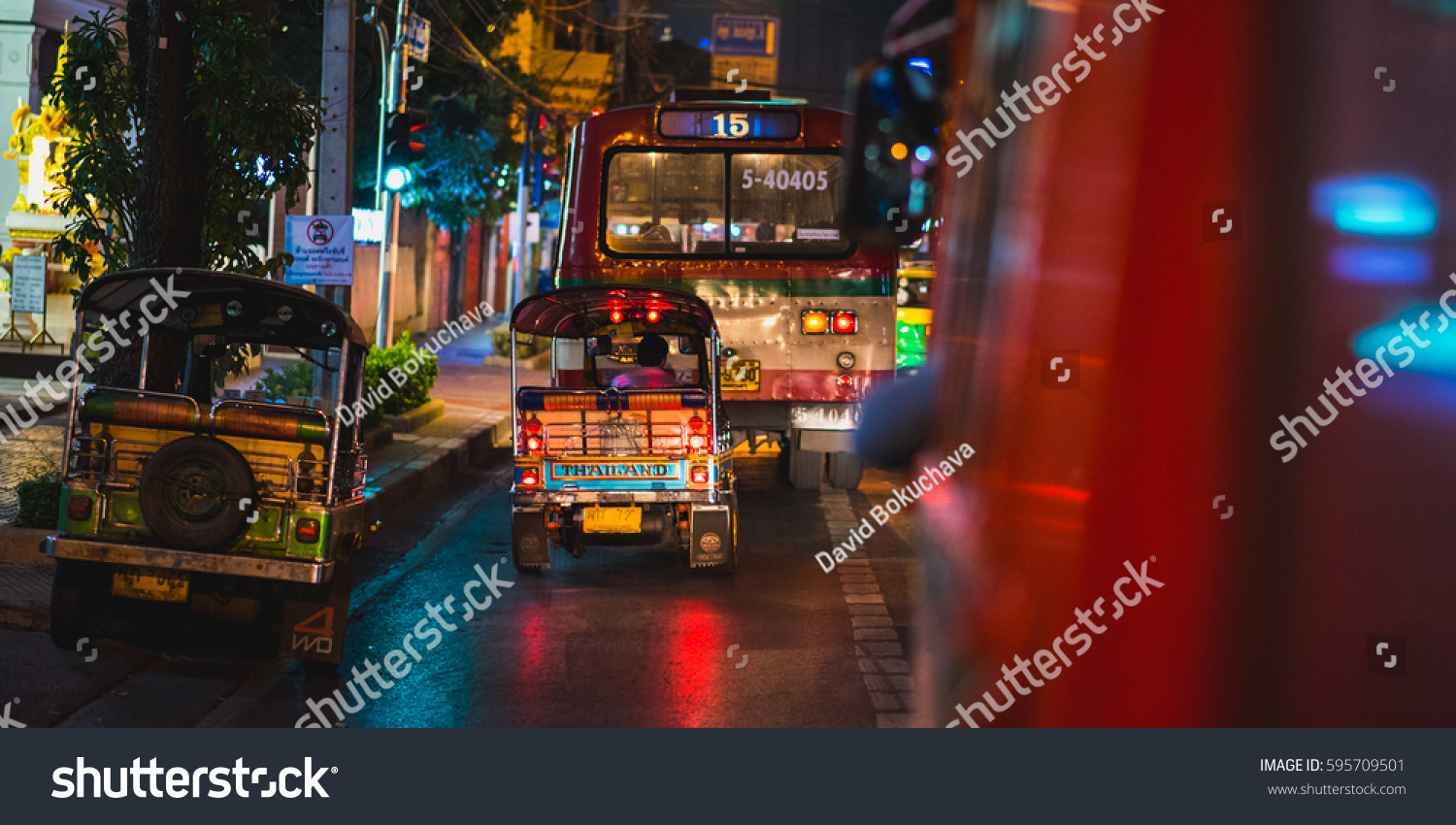 BANGKOK - FEBRUARY 18: Night ride a on public bus with tuk-tuks and a public bus view on February 18, 2017 in Bangkok, Thailand. #595709501