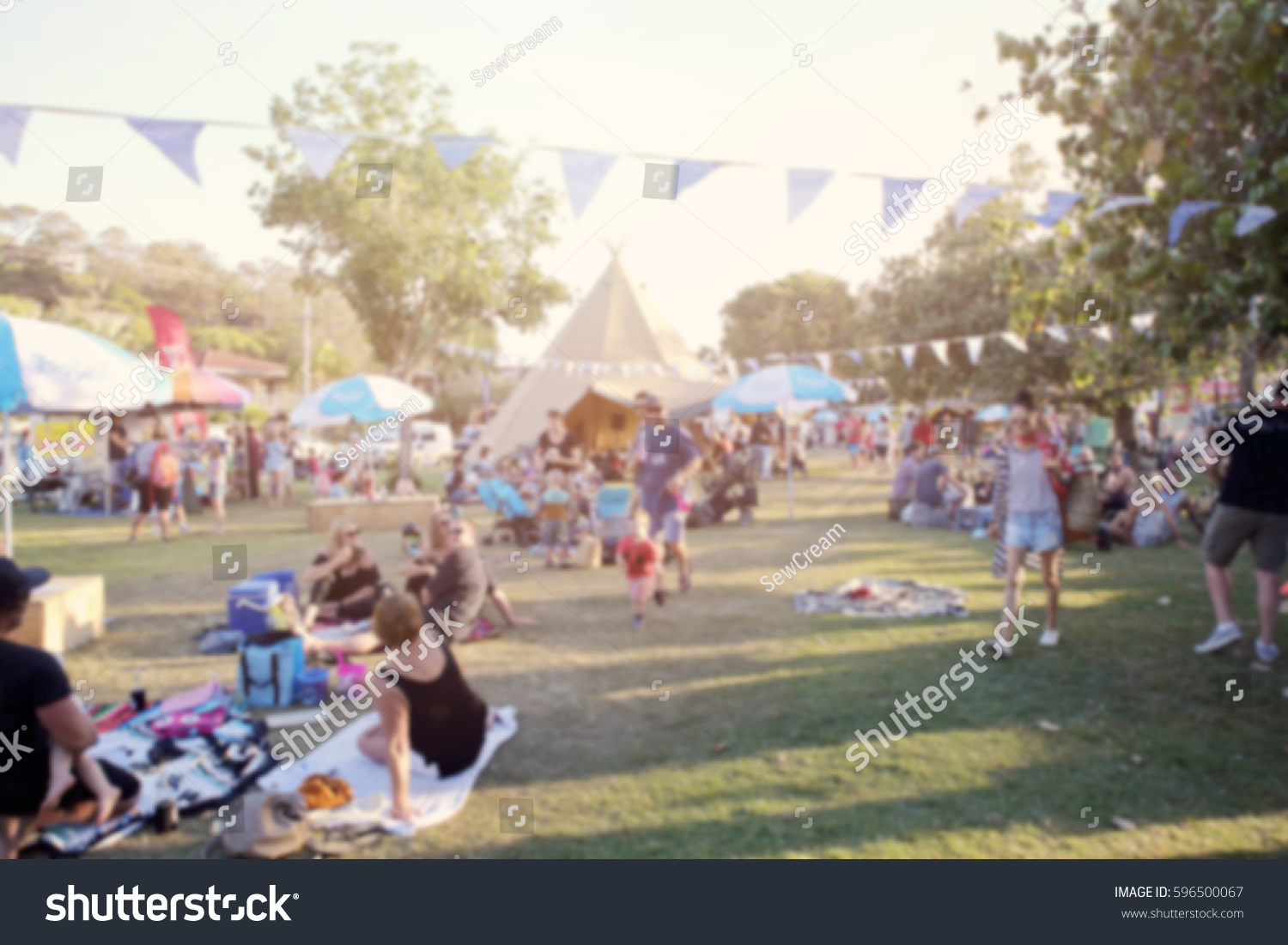 Blur defocused background of people, family in park fair, festive summer, music festival tent #596500067