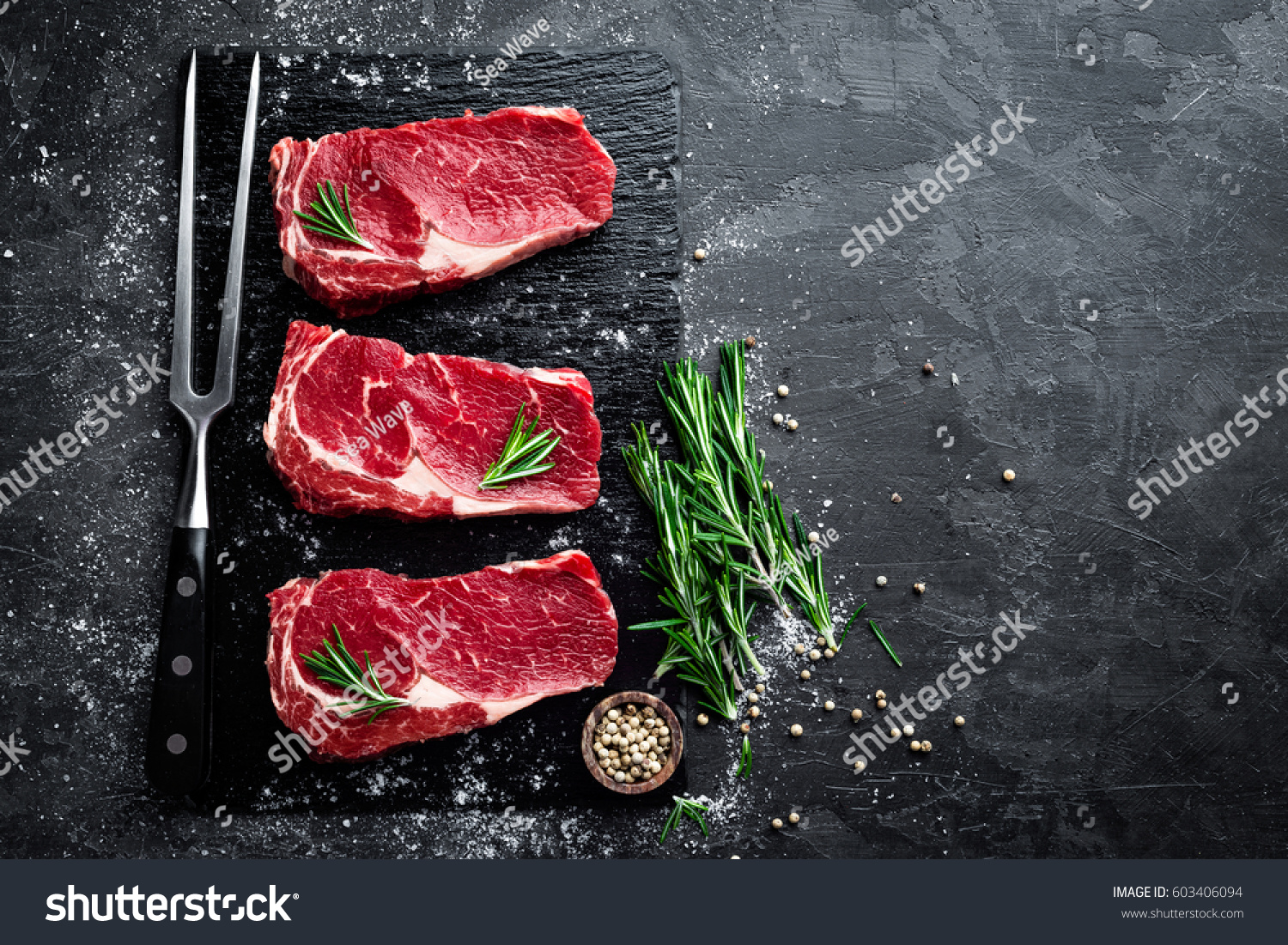 Raw meat, beef steak on black background, top view #603406094