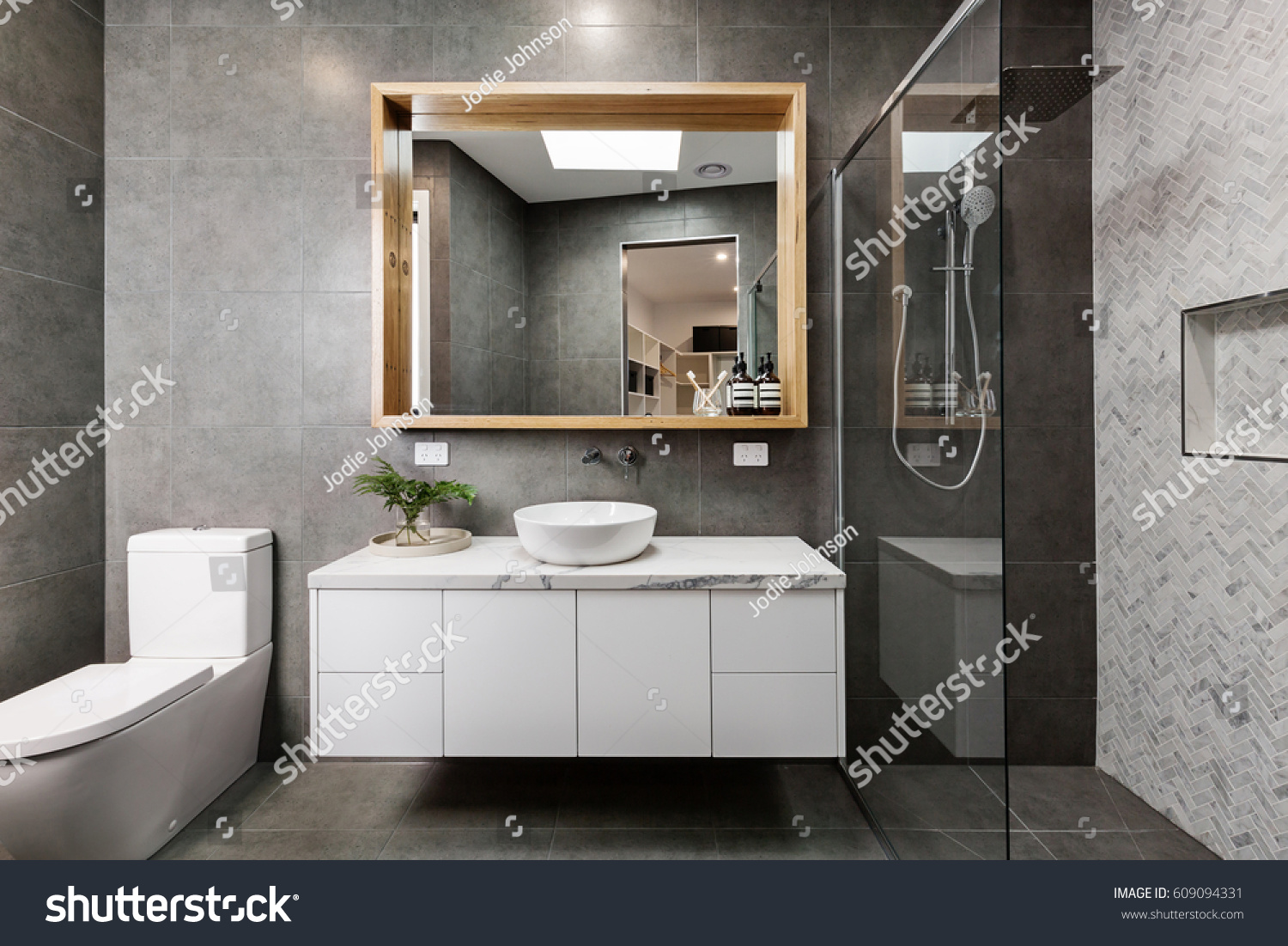 Modern grey designer bathroom with herringbone shower tiling #609094331