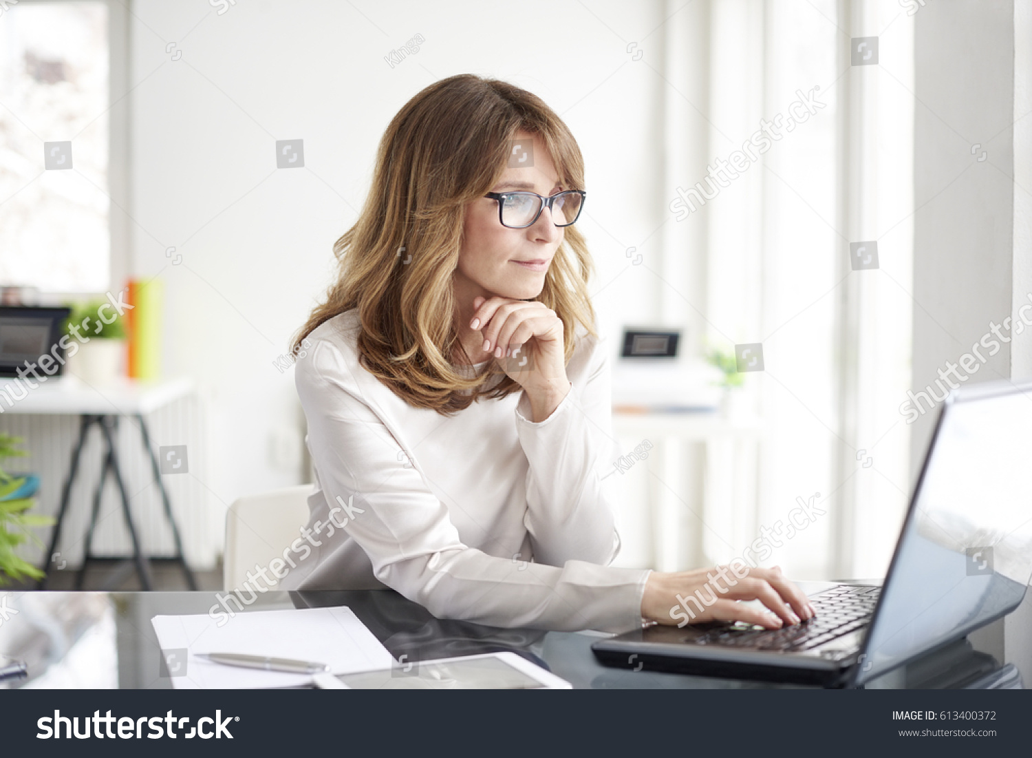 Shot of an attractive mature businesswoman working on laptop in her workstation. #613400372