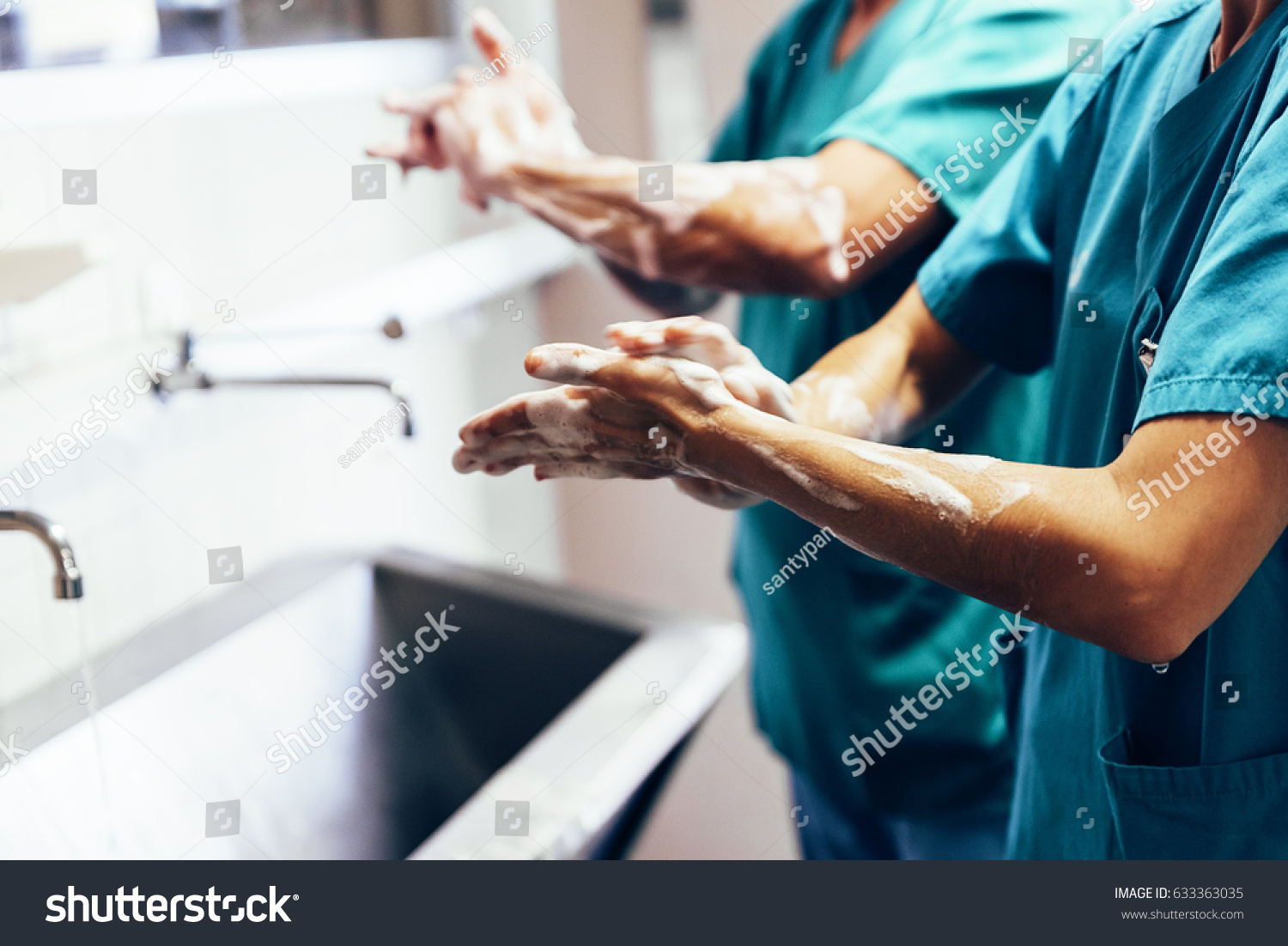 Couple of Surgeons Washing Hands Before Operating. Hospital Concept. #633363035