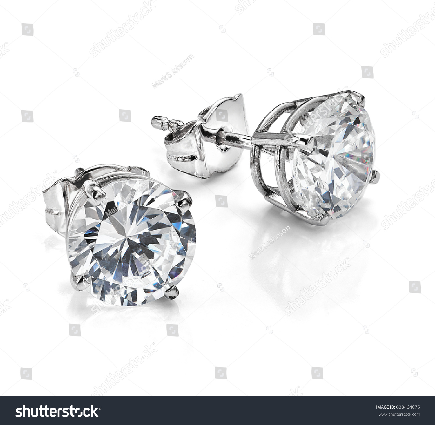Diamond earrings. Big diamond earrings, large solitaire earrings on white background. Four prong, four claw diamond earrings with posts and backs. Round brilliant cut diamonds.  #638464075