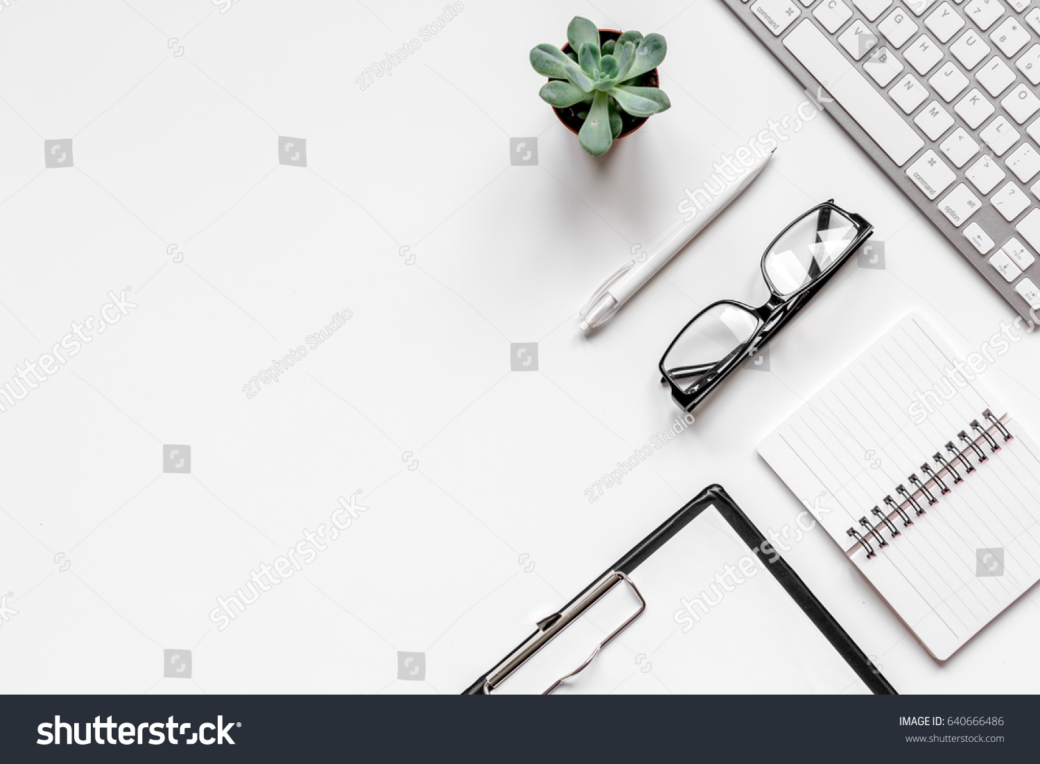 office flat lay with keyboard, glasses, notebook on white background top view mockup #640666486