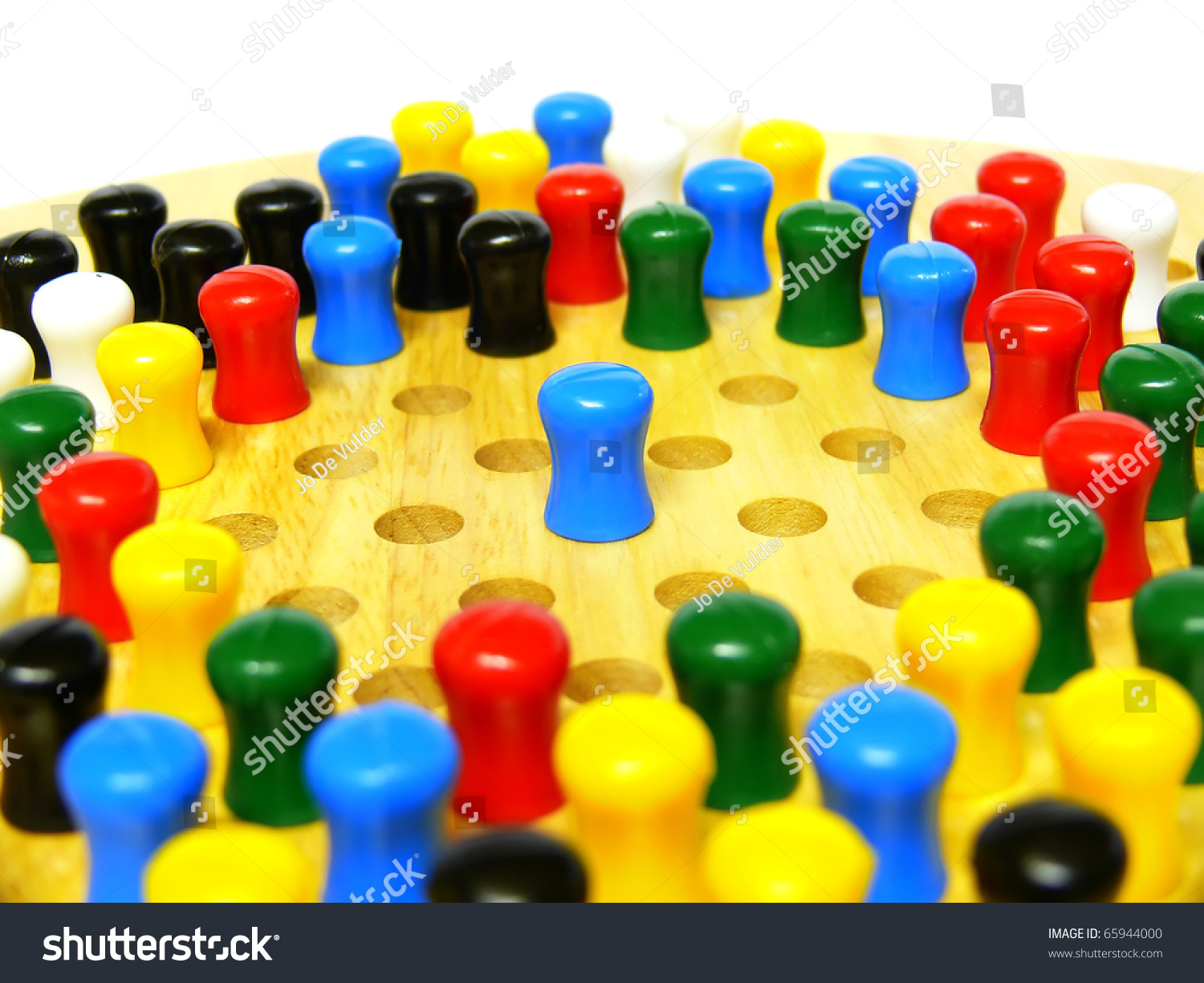 A blue peg on a chinese checkers board conceptually depicting being singled out, being alone #65944000