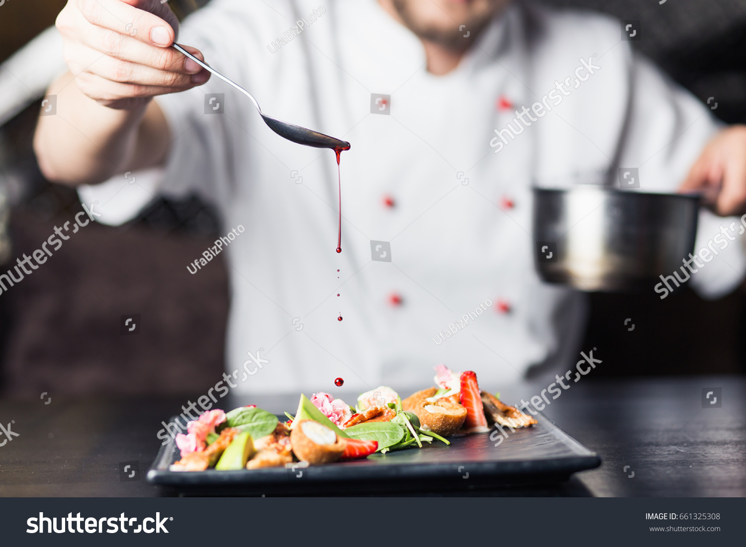 male cooks preparing meat in the restaurant kitchen #661325308