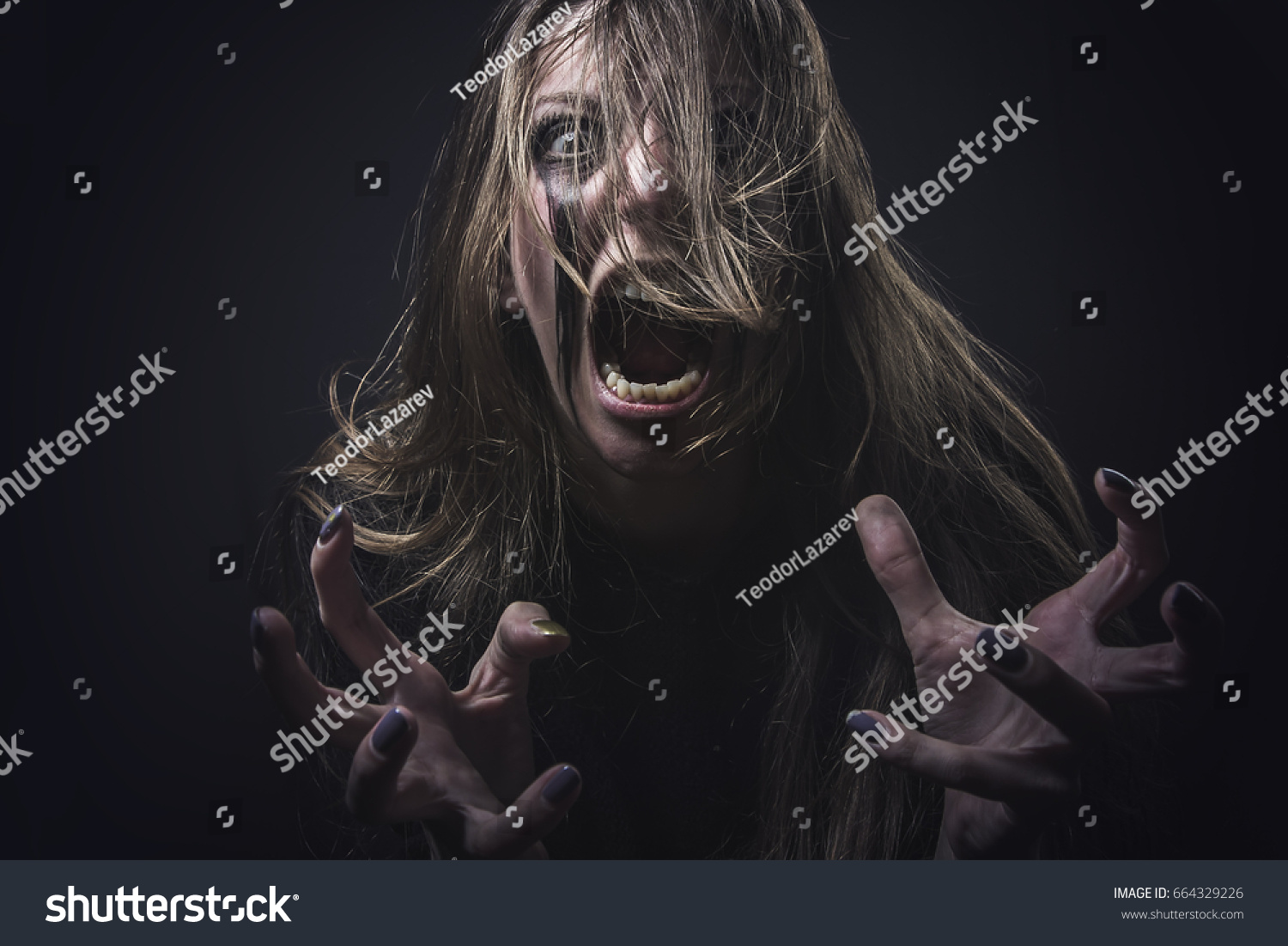 Crazy deranged woman pulling her hair out, scary and insane, halloween concept, possessed by evil spirits #664329226