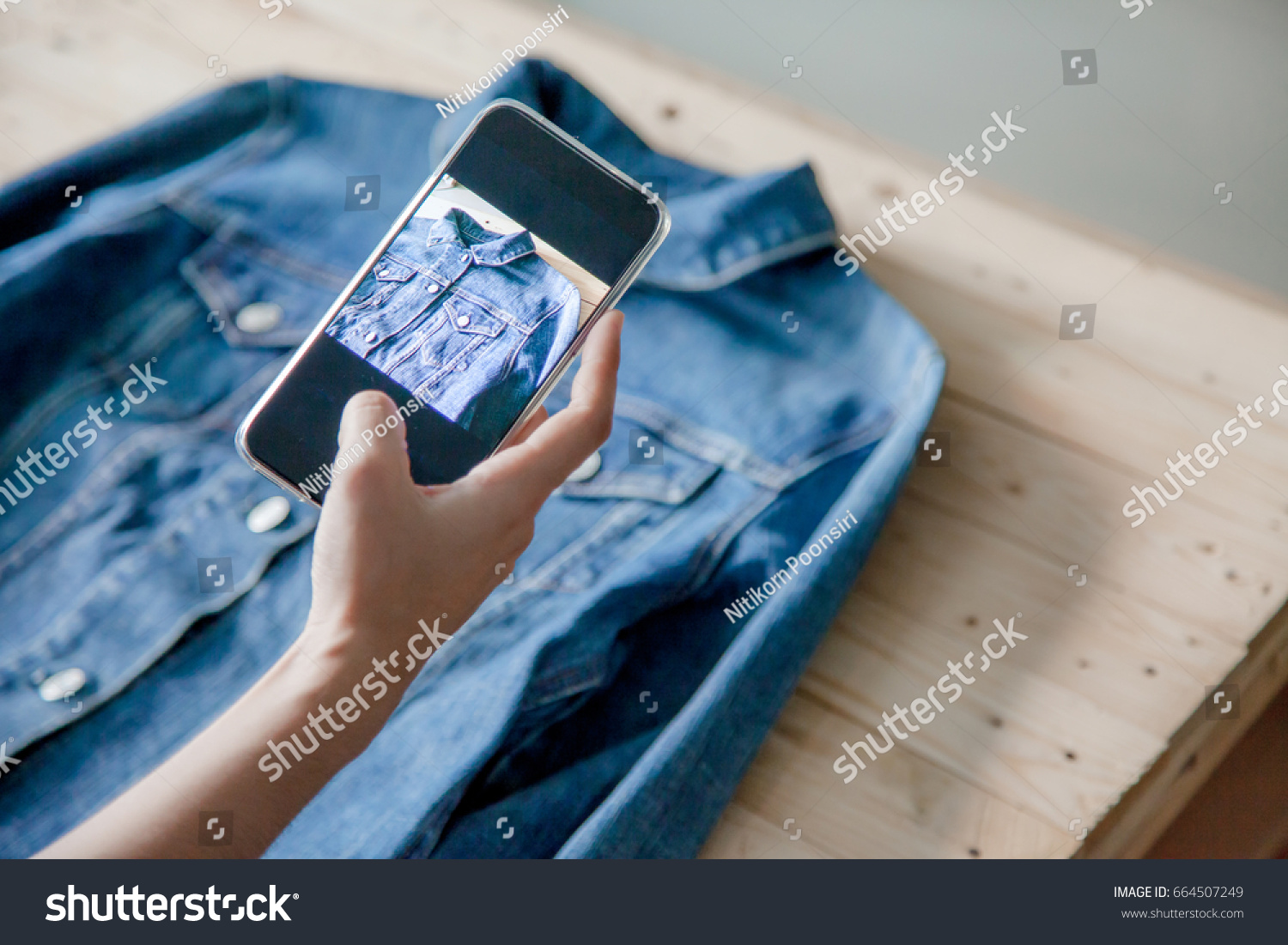 young Women taking photo to shirts with cell telephone or smartphone digital camera for Post to sell Online on the Internet . #664507249