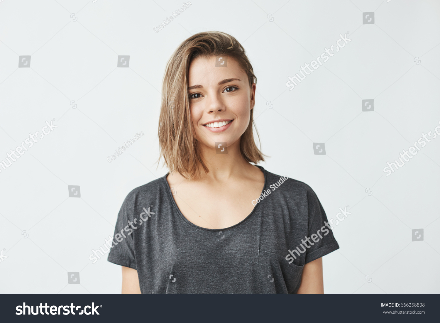 Portrait of young beautiful cute cheerful girl smiling looking at camera over white background. #666258808