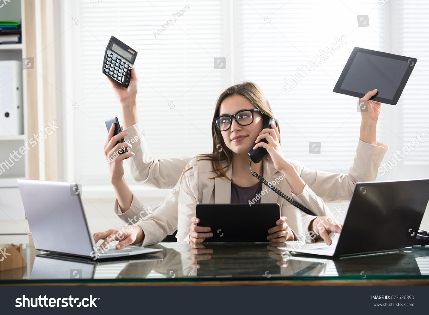 Busy Young Smiling Businesswoman With Six Arms Doing Different Type Of Work In Office #673636390