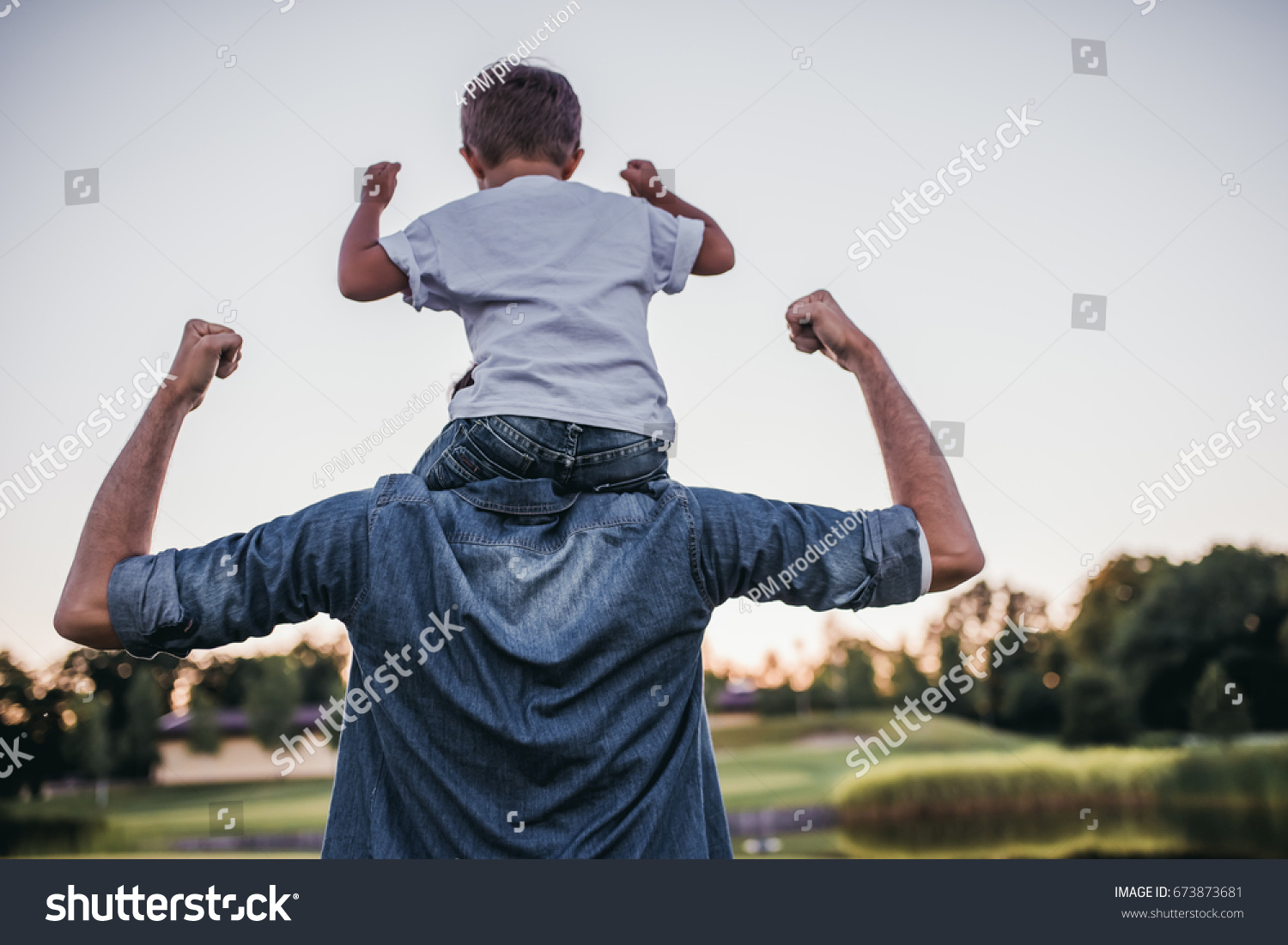 Dad and son having fun outdoors. #673873681