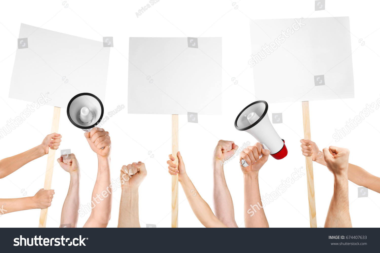Raised human hands with megaphones and placards on white background. Strike and protest concept #674407633
