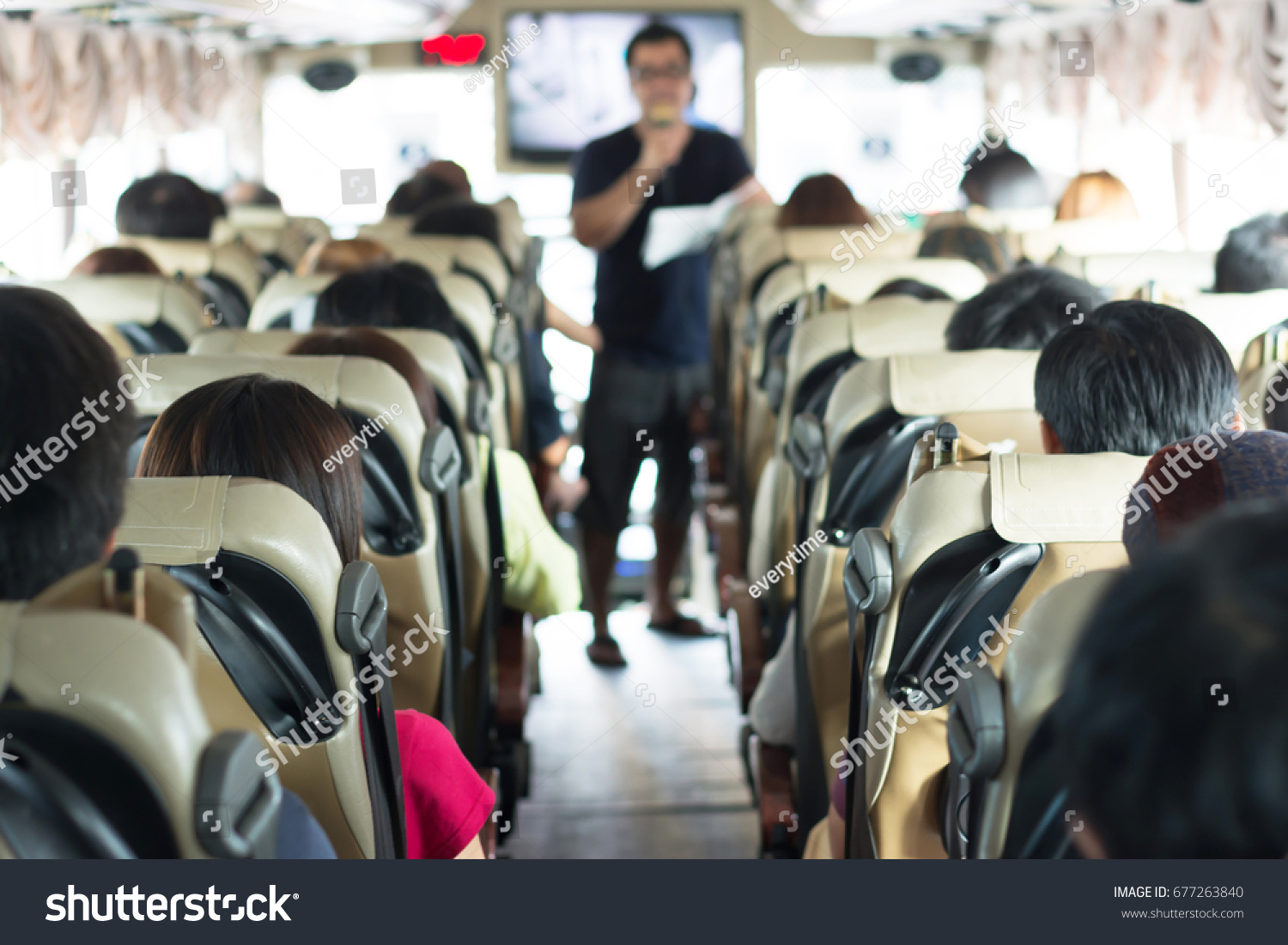 Selective focus image of Private bus with tourists and guided tour. #677263840