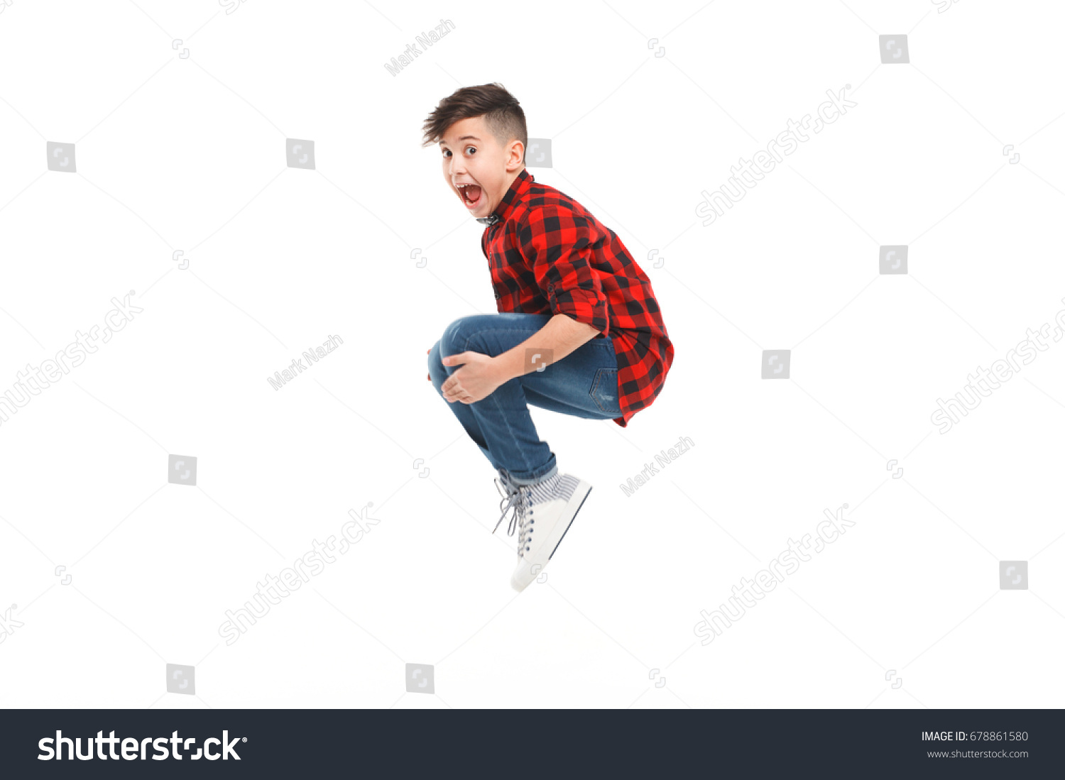 Side view of excited young boy jumping isolated on white.  #678861580
