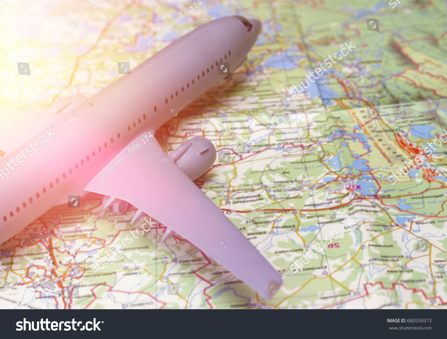 Plane on the map. Traveling abroad, international flights, flight, airlines. In the rays of sunset #680550973