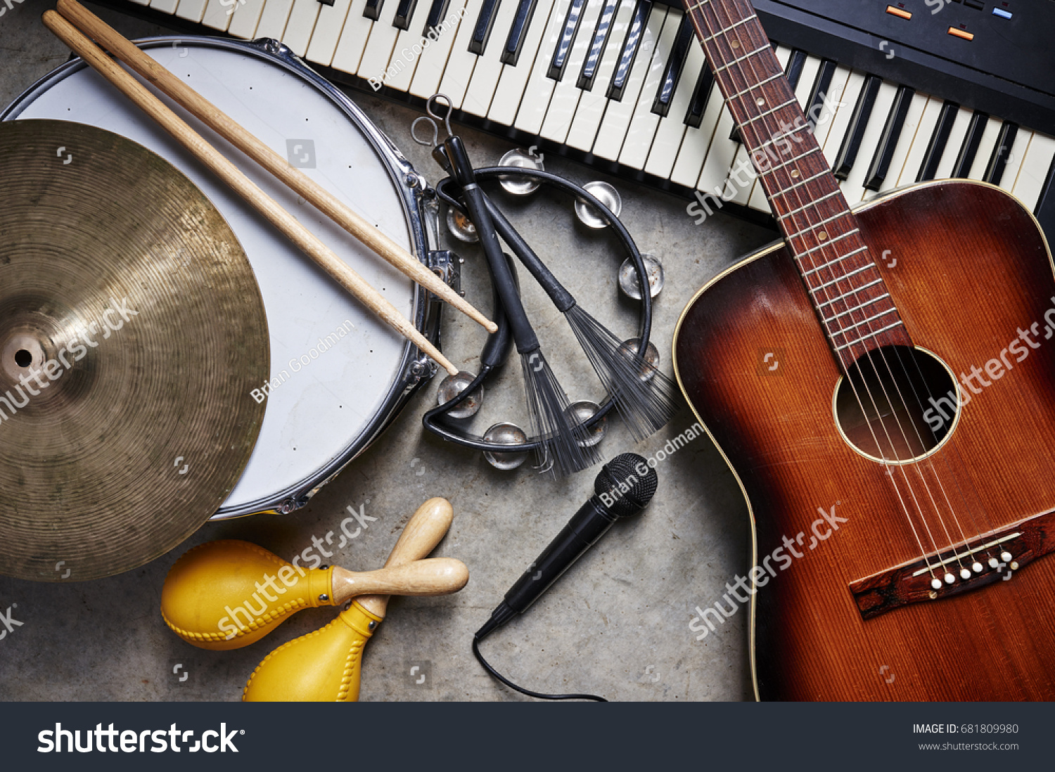 a group of musical instruments including a guitar, drum, keyboard, tambourine. #681809980