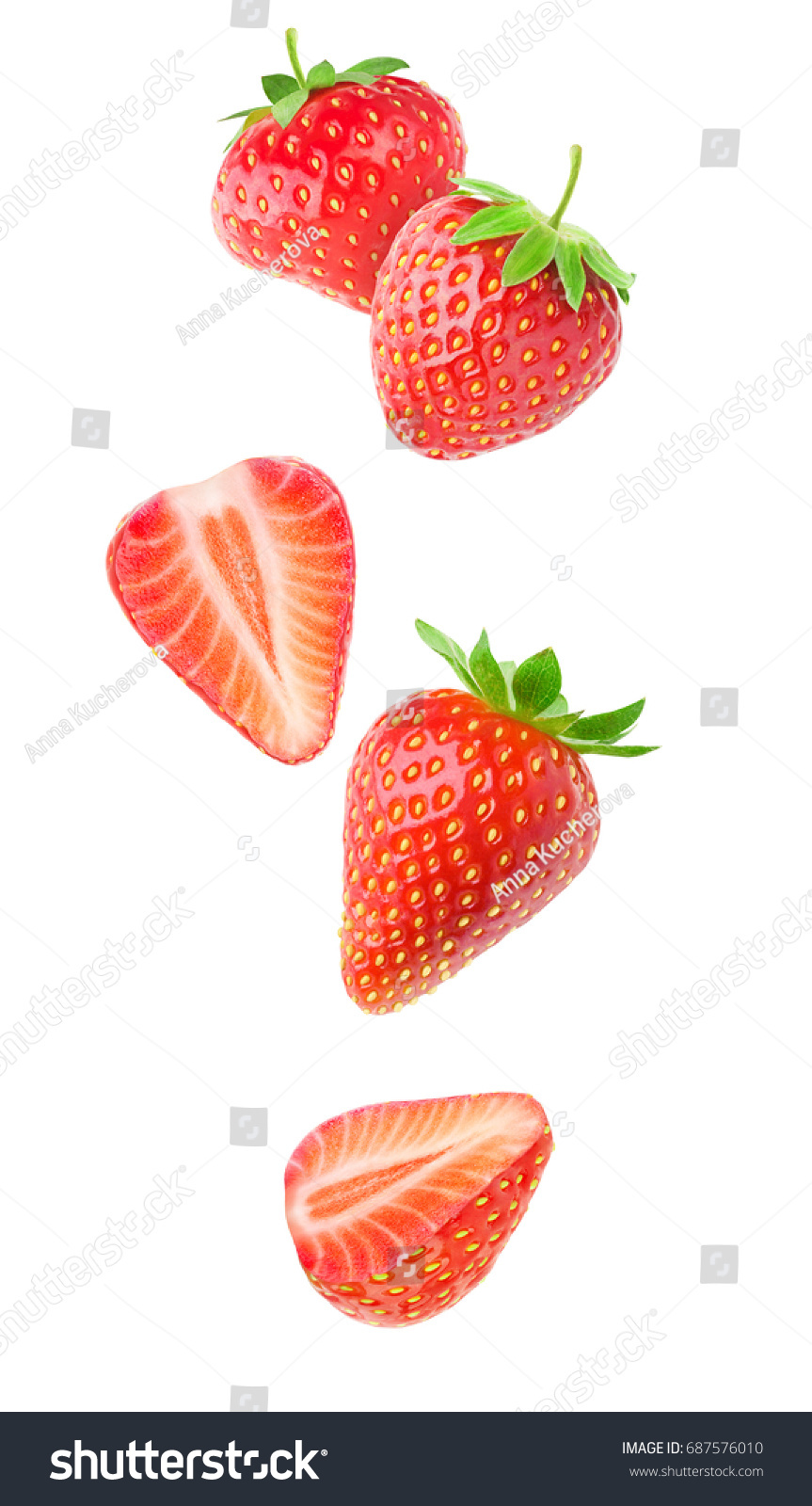 Isolated strawberries. Falling strawberry fruits whole and cut in half isolated on white background with clipping path #687576010