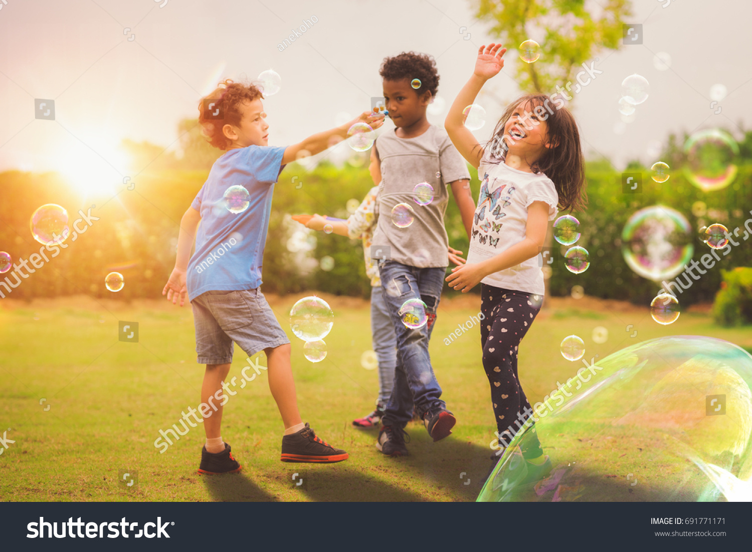 Kid and friends in international preschool play a bubble in playground with sunset background, kid, child, school, play and summer background #691771171