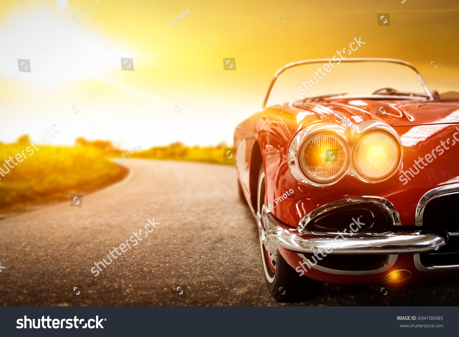 retro car on road and golden autumn space  #694100485