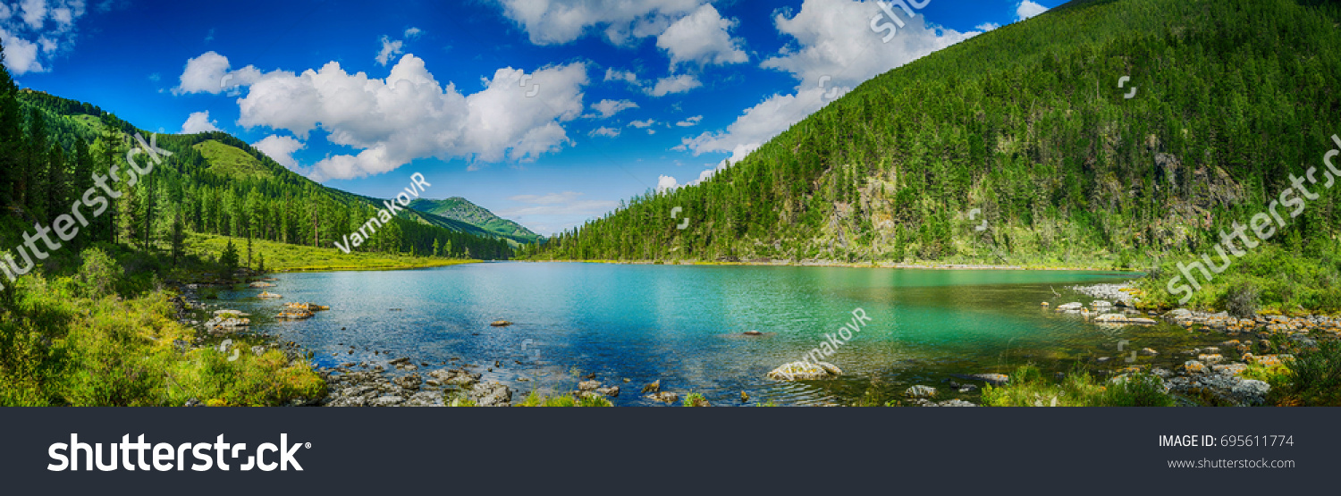 Panoramic view on mountain lake in front of mountain range, national park in Altai republic, Siberia, Russia #695611774