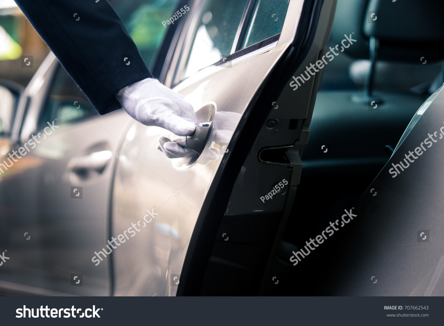 Closeup of Chauffeur opening car door with glove #707662543