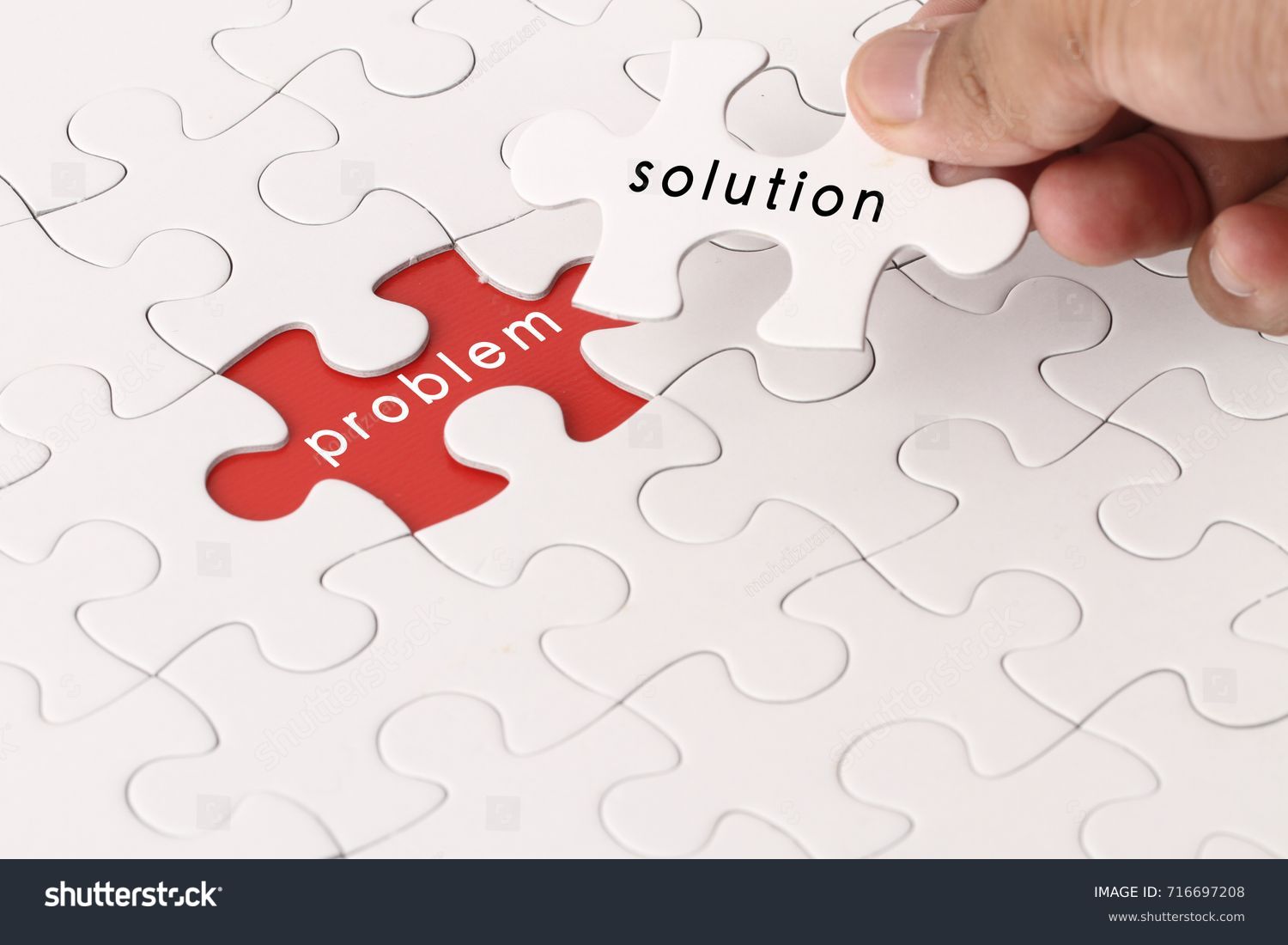 Management concept with hand holding piece of jigsaw puzzle with problem and solution wording #716697208