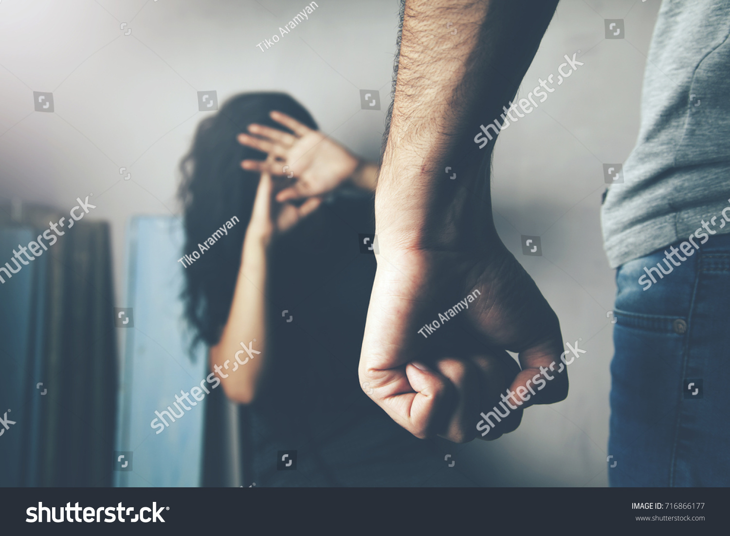 Man beating up his wife illustrating domestic violence #716866177