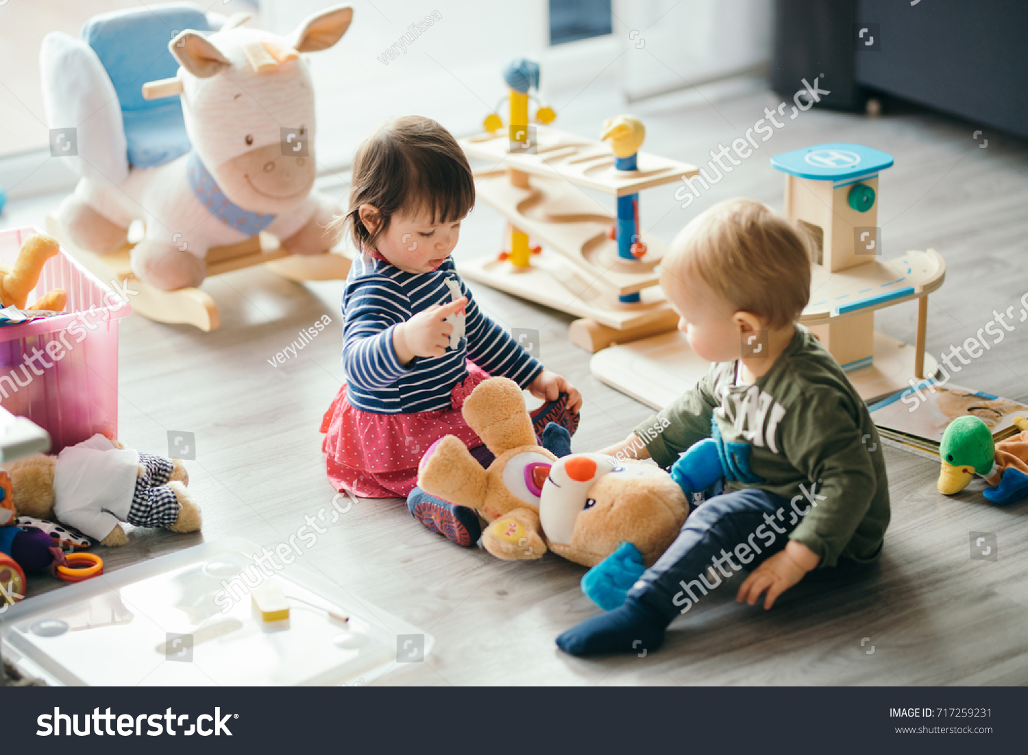 cute little girl and boy playing with toys by the home #717259231
