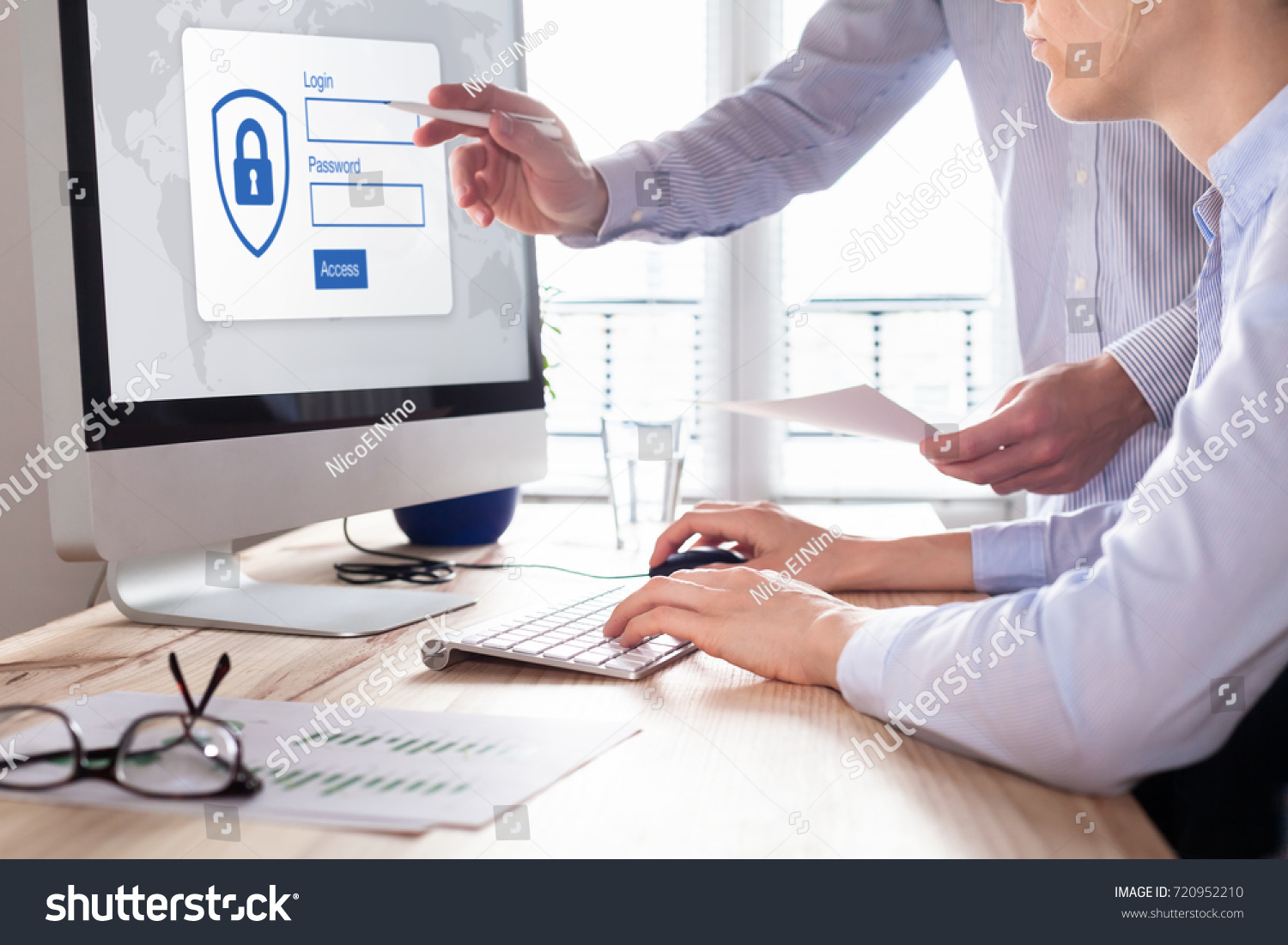 Cyber security concept with manager providing authentication credentials (login, password) to business person to access confidential data on computer screen #720952210