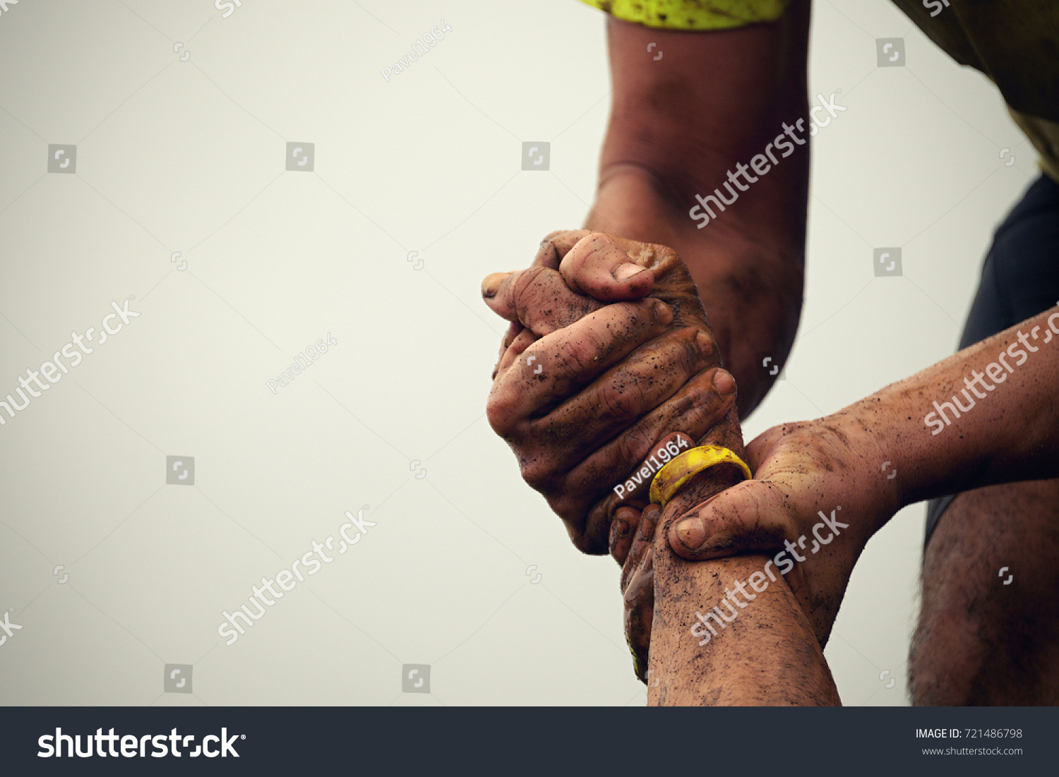 Mud race runners.Couple hold hands,help when overcoming hindrances mud #721486798
