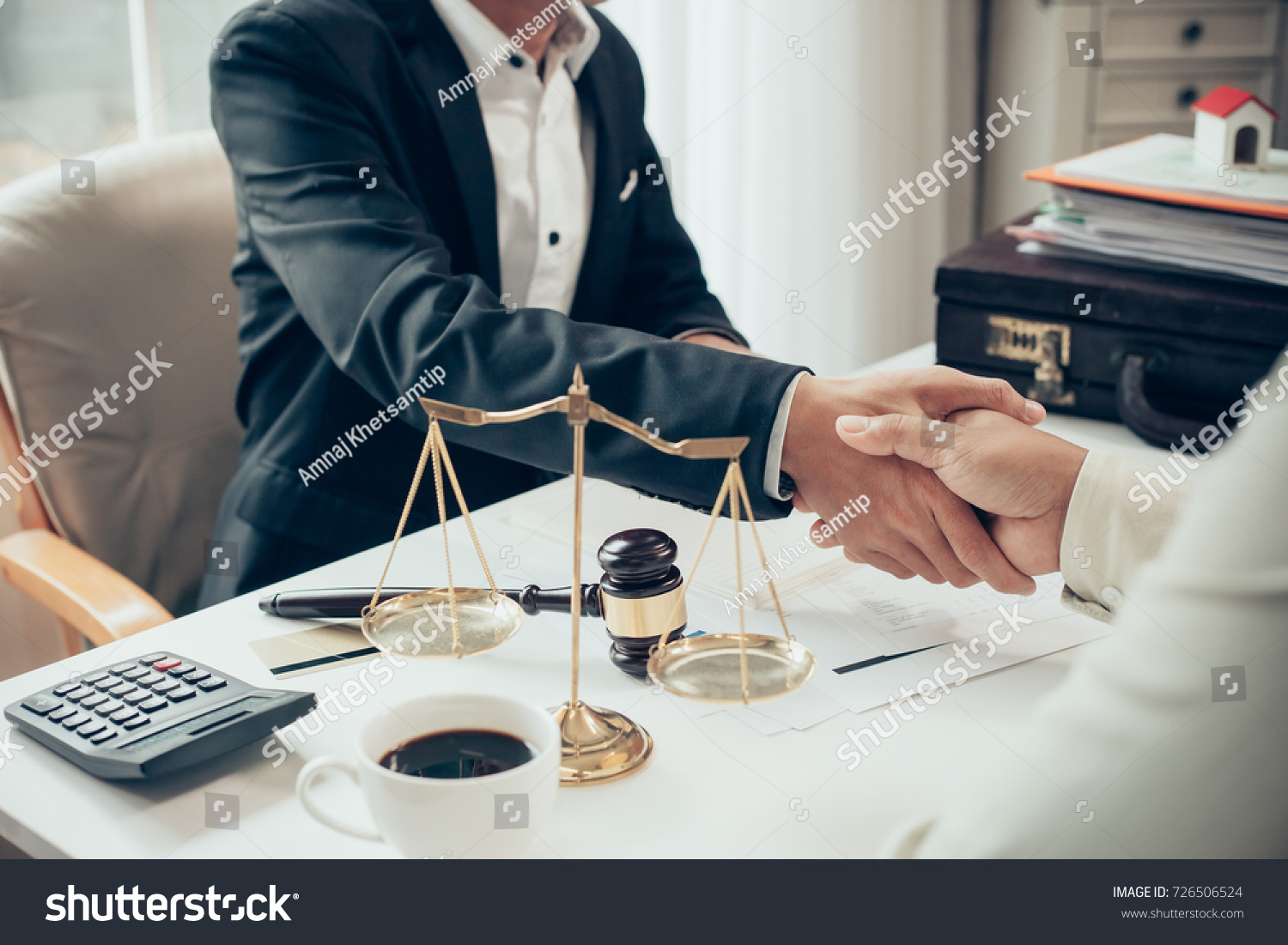 Businessman shaking hands to seal a deal with his partner lawyers or attorneys discussing a contract agreement #726506524