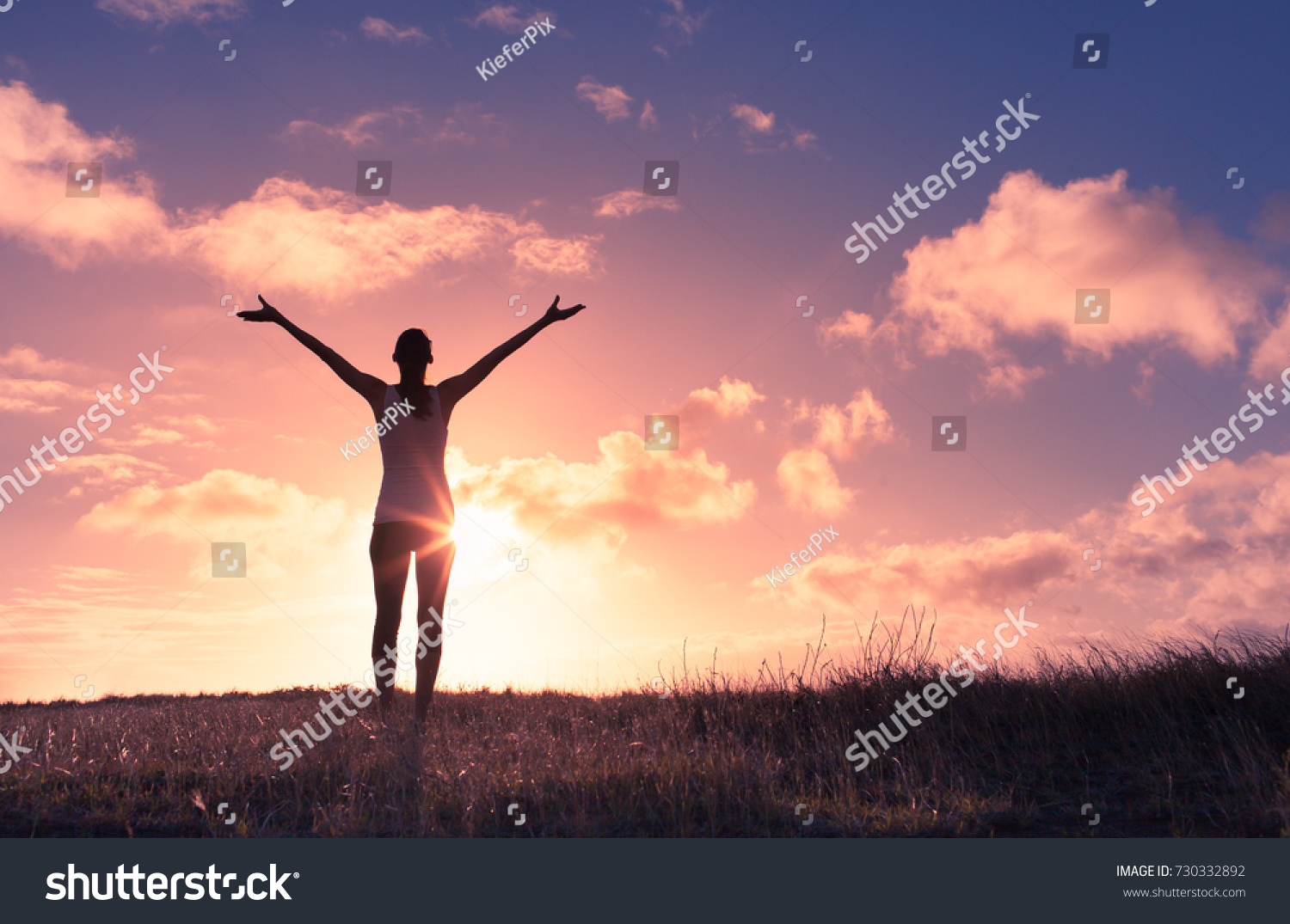 It's a beautiful life. Happy woman with arms up in the sunset.  #730332892